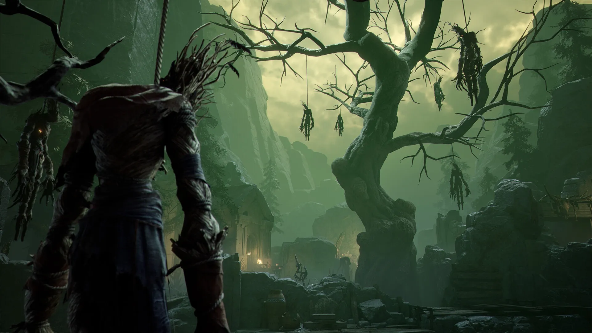 Mistfall Hunter: Hooded character in eerie forest clearing with hanging figures from twisted tree