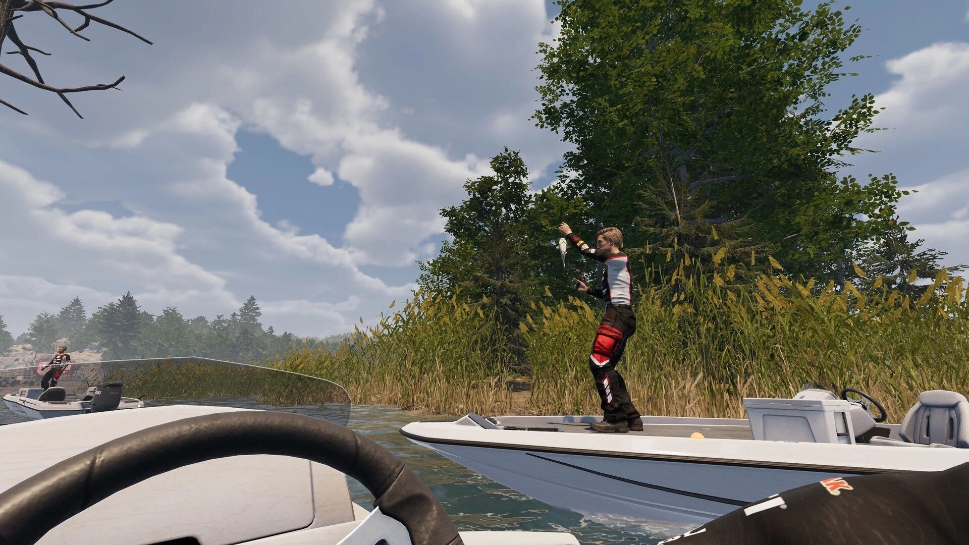 MLF: Angler on boat holds up a caught fish near tall reeds and trees on a cloudy lake shore.