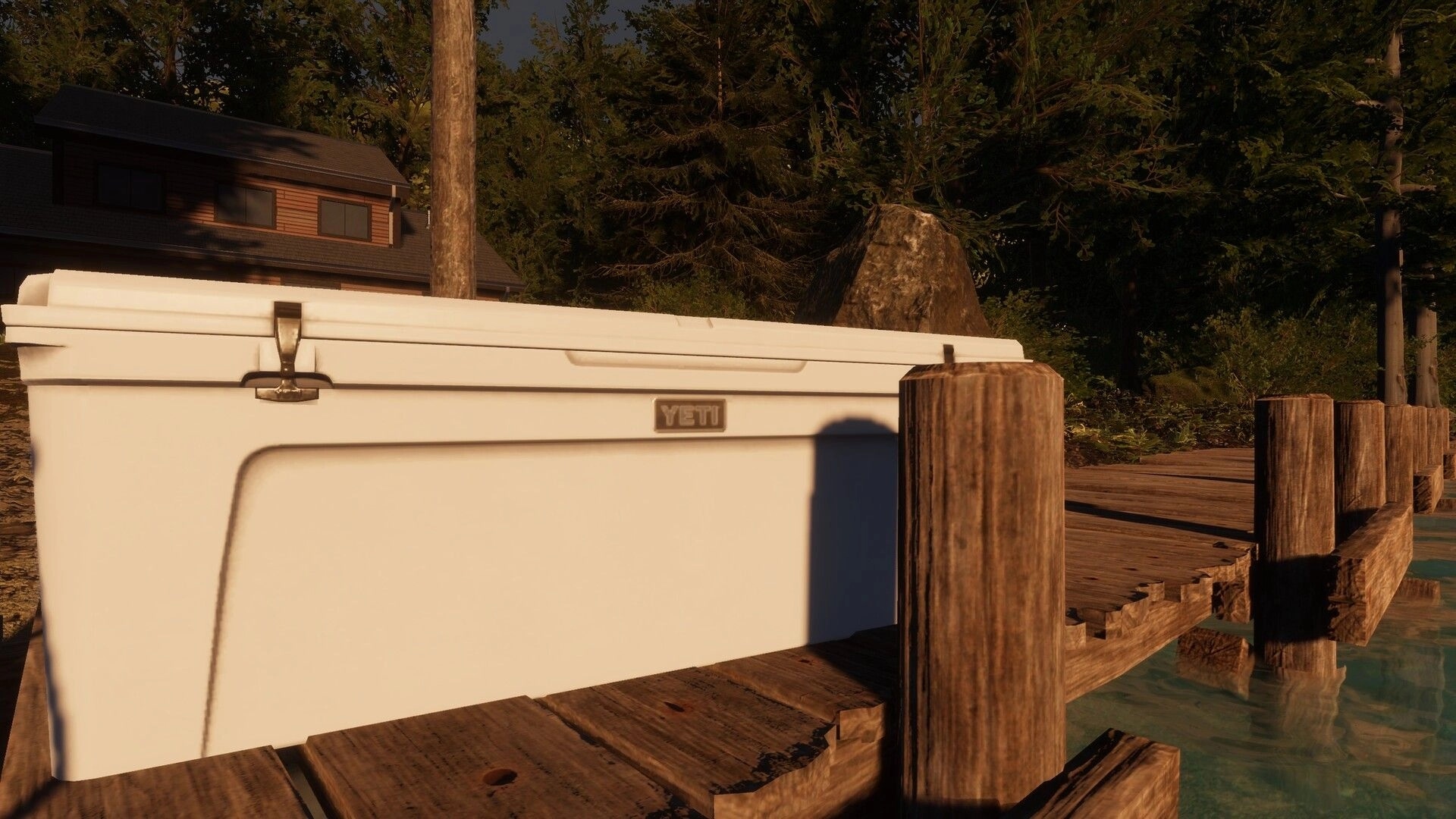 MLF: Close-up of a white YETI cooler on a wooden dock by calm water and forest cabin backdrop.