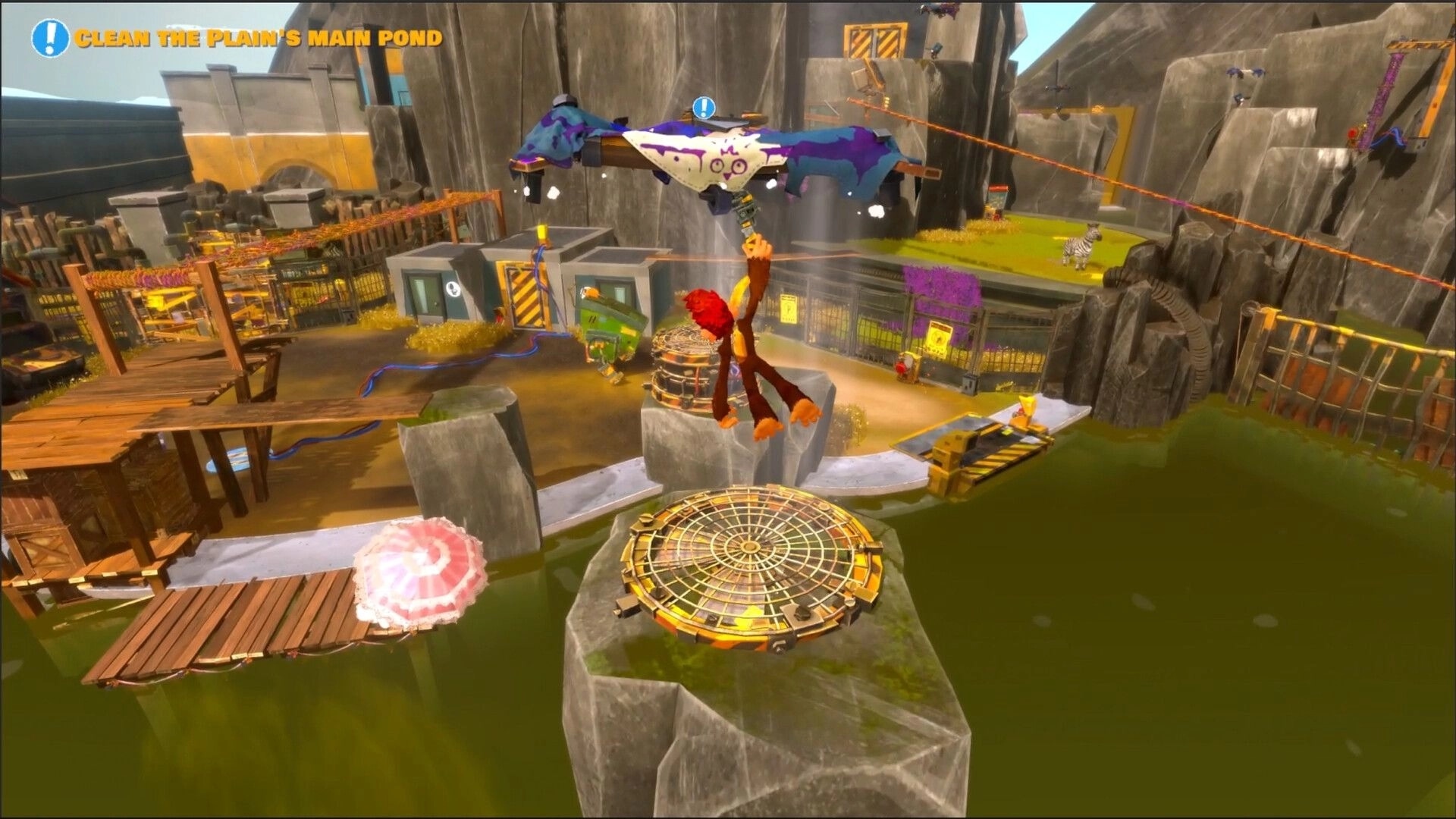 Monkey Do!: Mak swings from a paint-splattered drone above a murky pond in a rocky zoo yard.