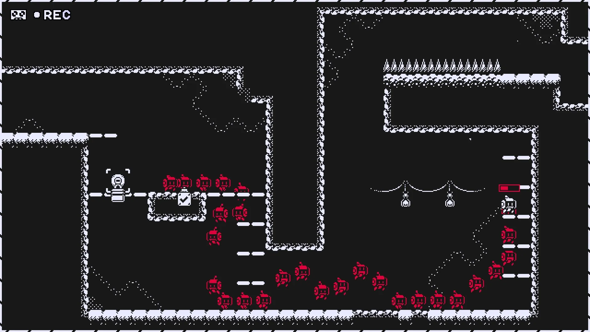 MotionRec: Player records movement past red enemies and spikes in a cavernous puzzle platformer level.
