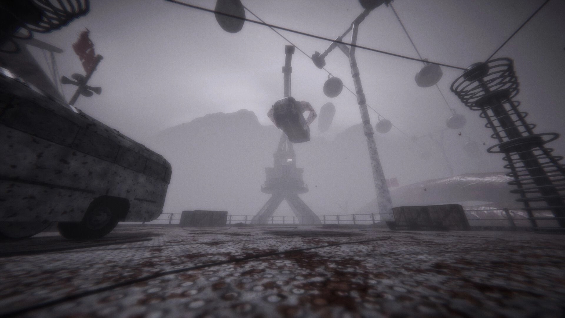 MOULD: Foggy dockyard view of a towering crane and hanging cables amid rusted industrial debris.