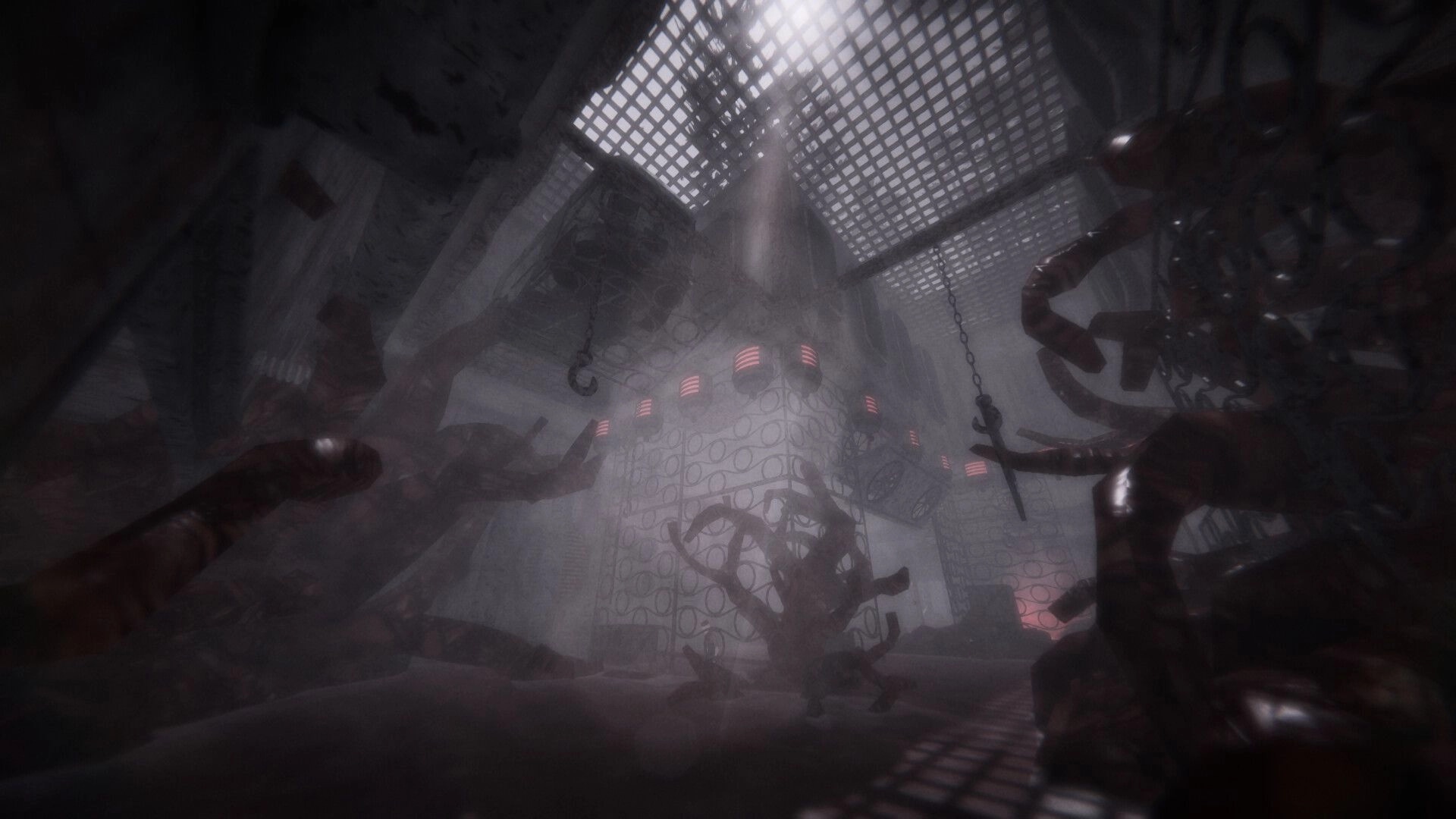 MOULD: View up at a foggy industrial chamber with dangling hooks, pipes, and red-lit tower core.