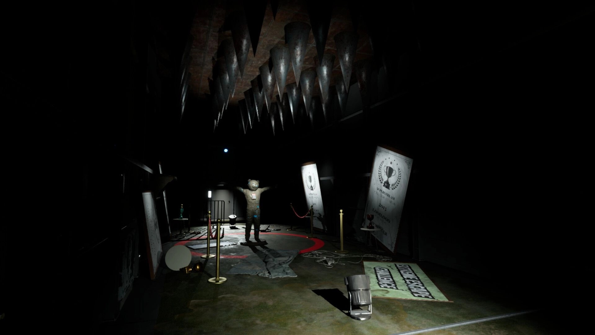 Mr Wonder: Dark room with bear figure under spikes, surrounded by ropes and award posters