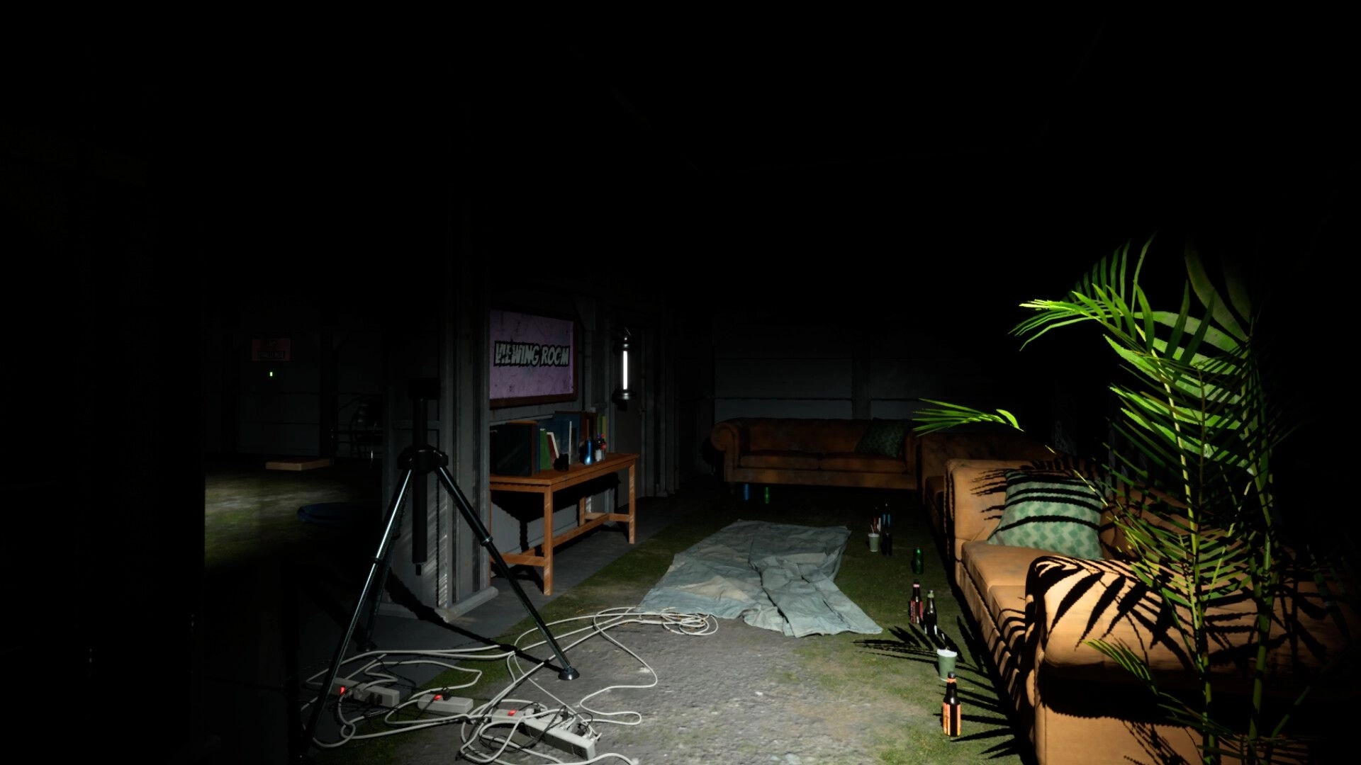 Mr Wonder: Dimly lit studio with scattered cables, couches, and a tripod in a shadowy viewing room