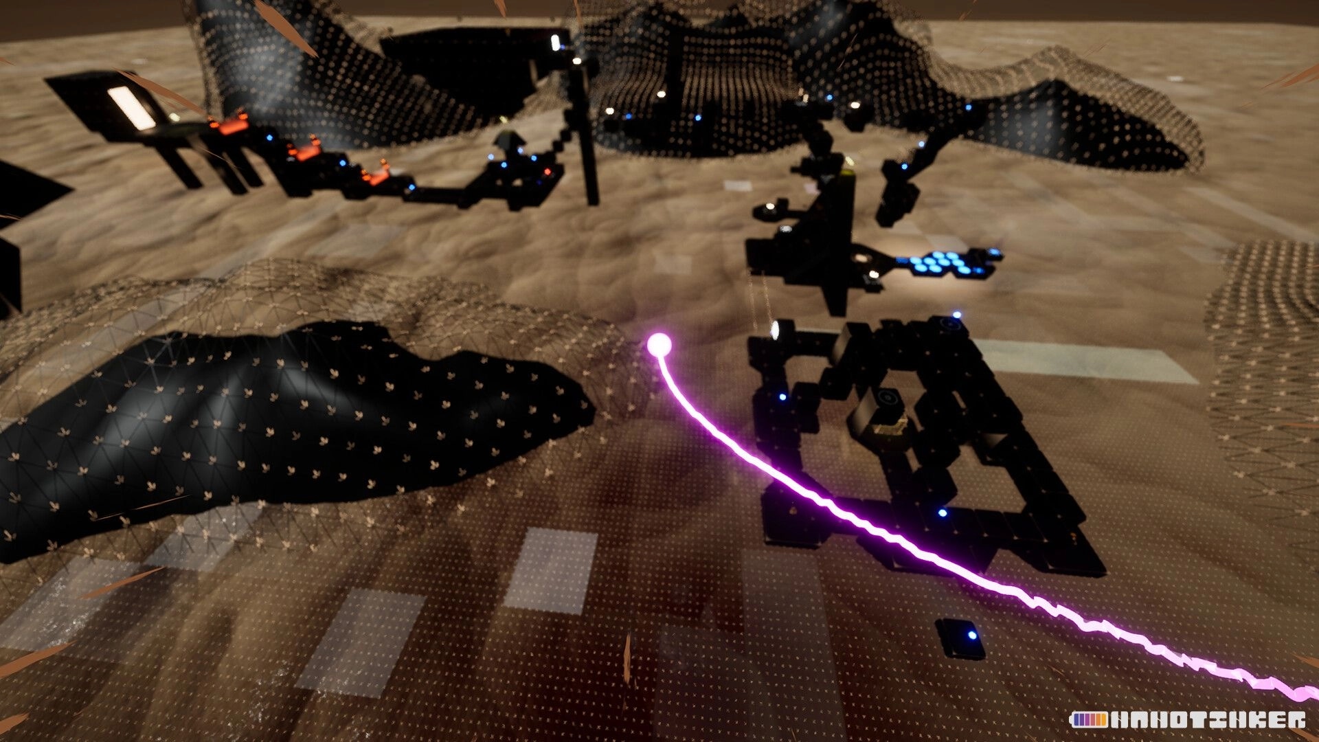 NANOTINKER: Purple energy beam arcs over black block platforms in a sandy abstract landscape.