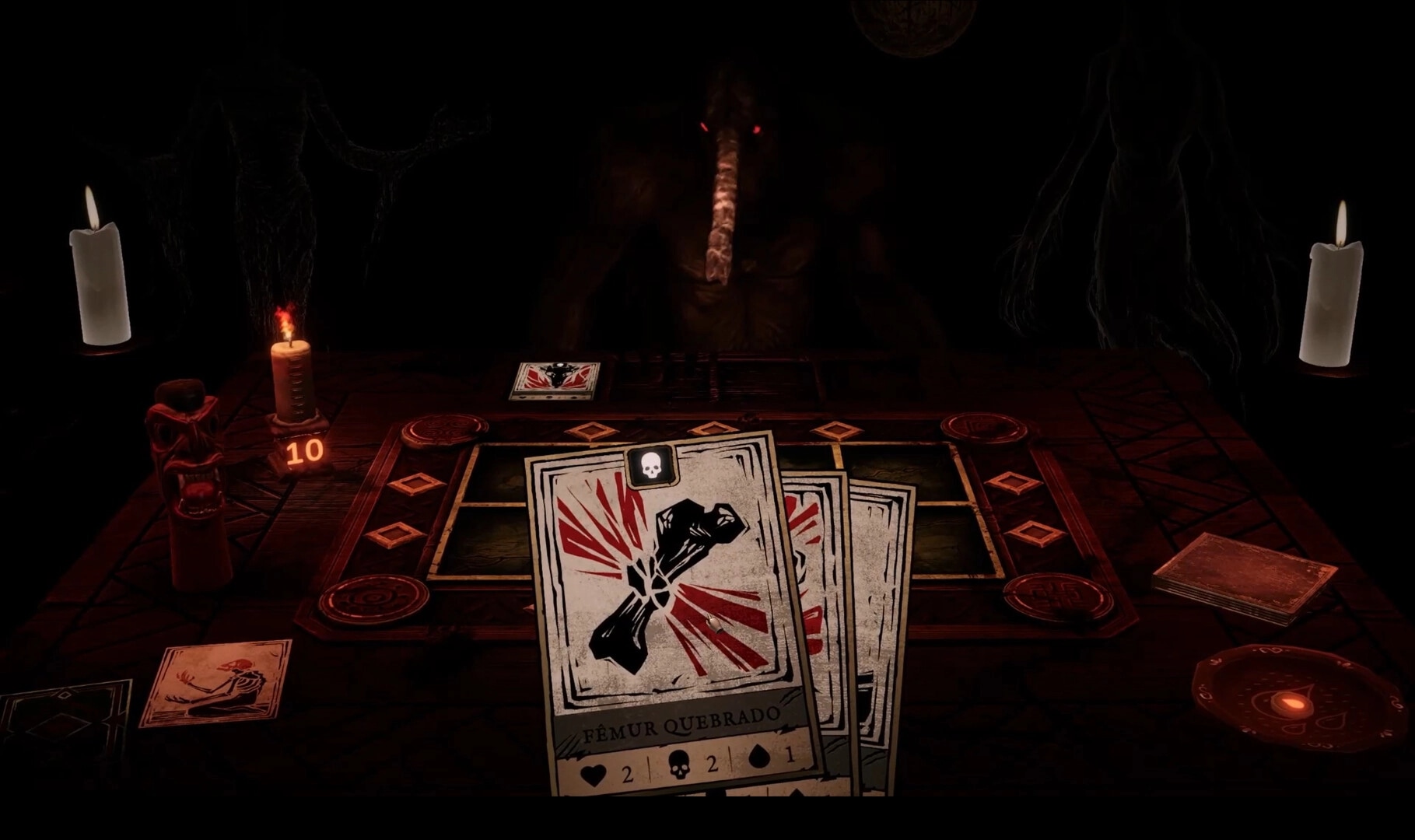 Obscurium: Broken femur card played on a ritual board, candles lit, shadowy foe with red eyes ahead.