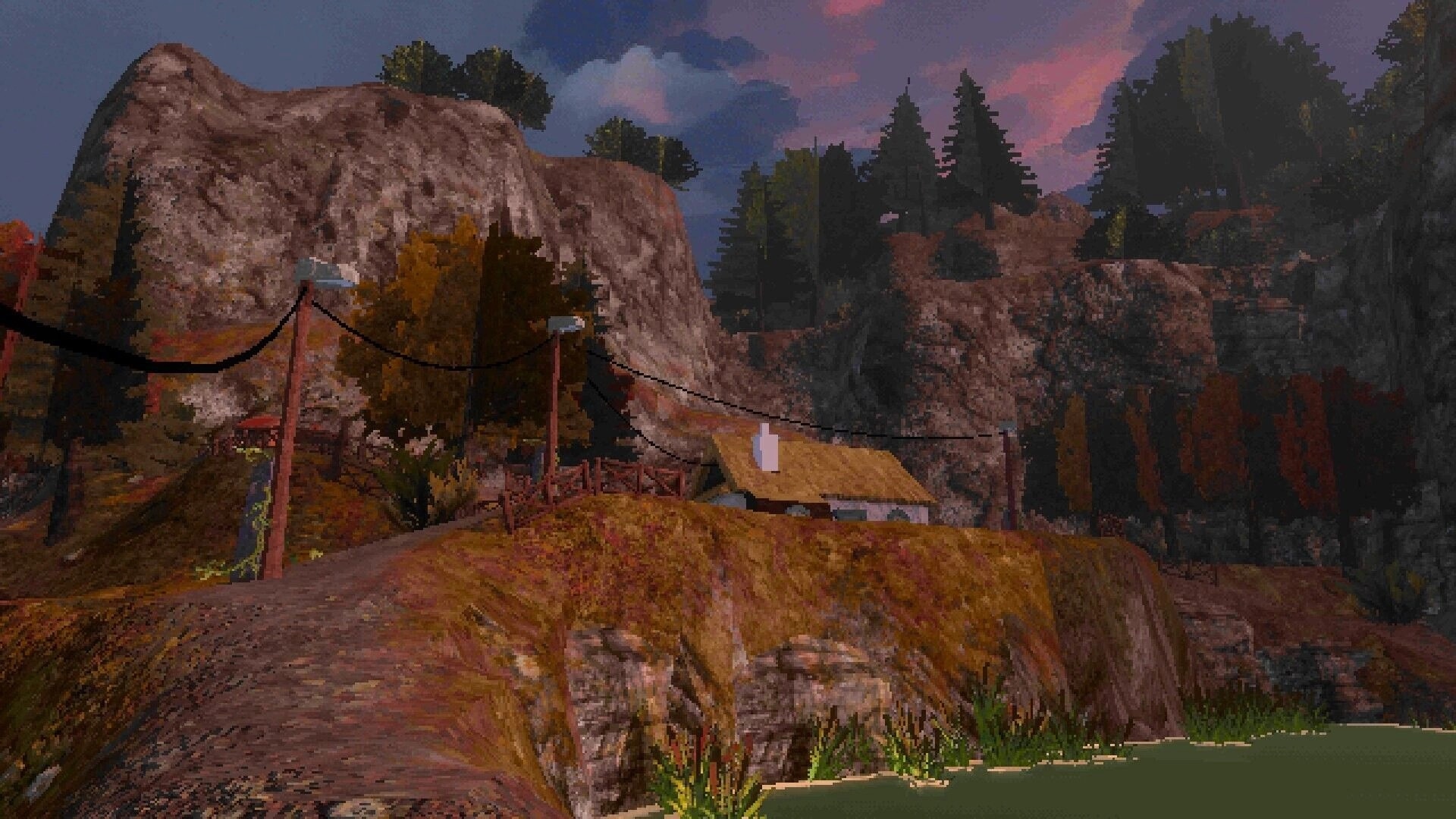 OKUREK: Dirt road with power lines and small cabin beneath cliffs in a misty mountain valley at dusk.