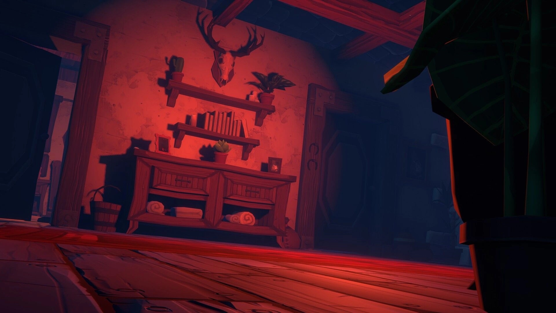Olga: First-person view of a dim room with deer skull, shelves and cabinet under red light glow.
