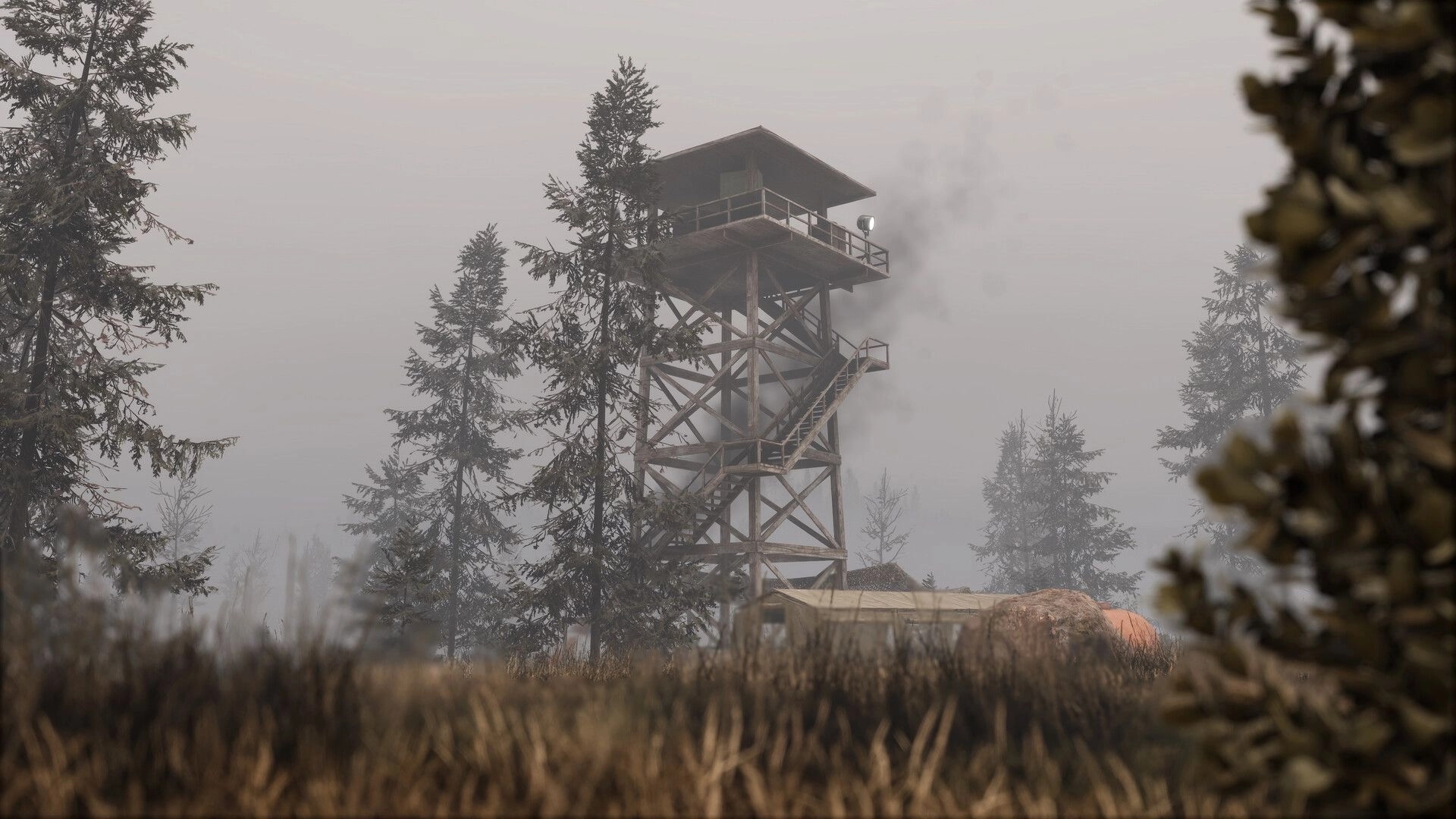ORMOD: Wooden watchtower with stairs and balcony rising above pines in a foggy forest clearing.