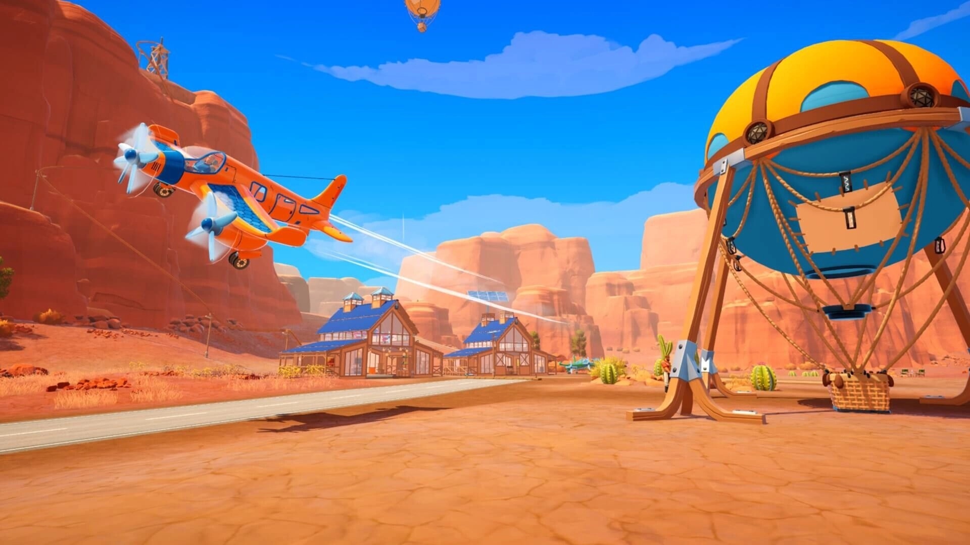 Outbound: Orange prop plane flies past a tethered balloon platform in a red canyon airstrip town.