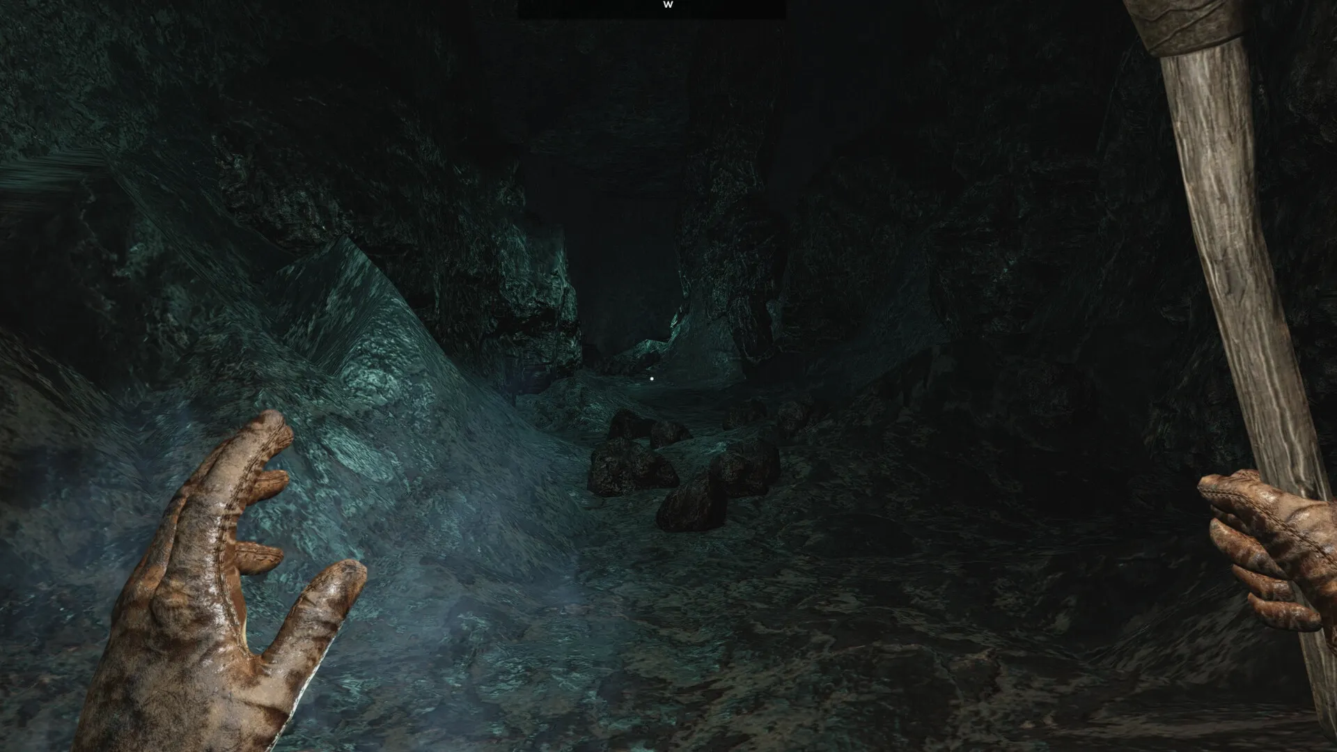 Outwith: Exploring dark cave passage with torch in hand, rocky terrain and faintly glowing path ahead.