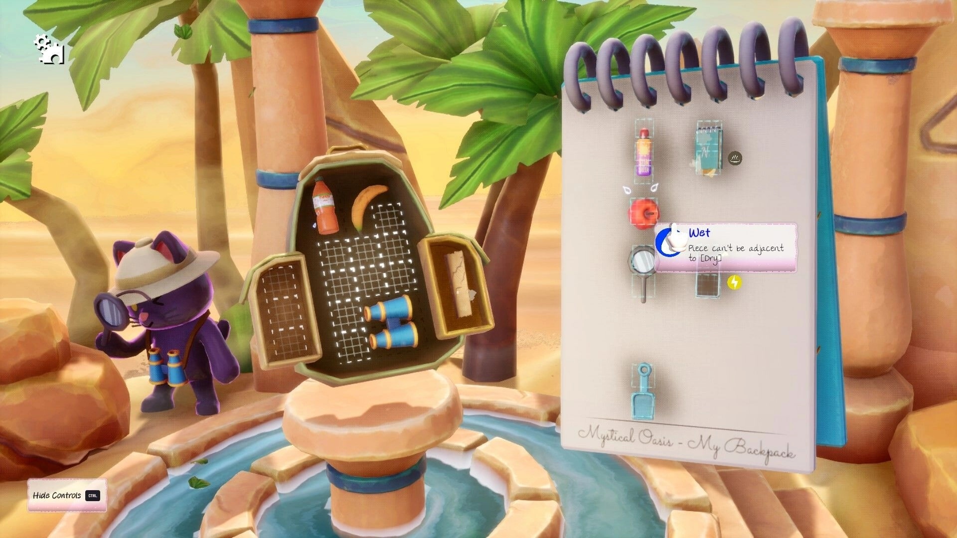 Pakinpaks: Cat character examines items beside a fountain in a desert with open packing list notes.