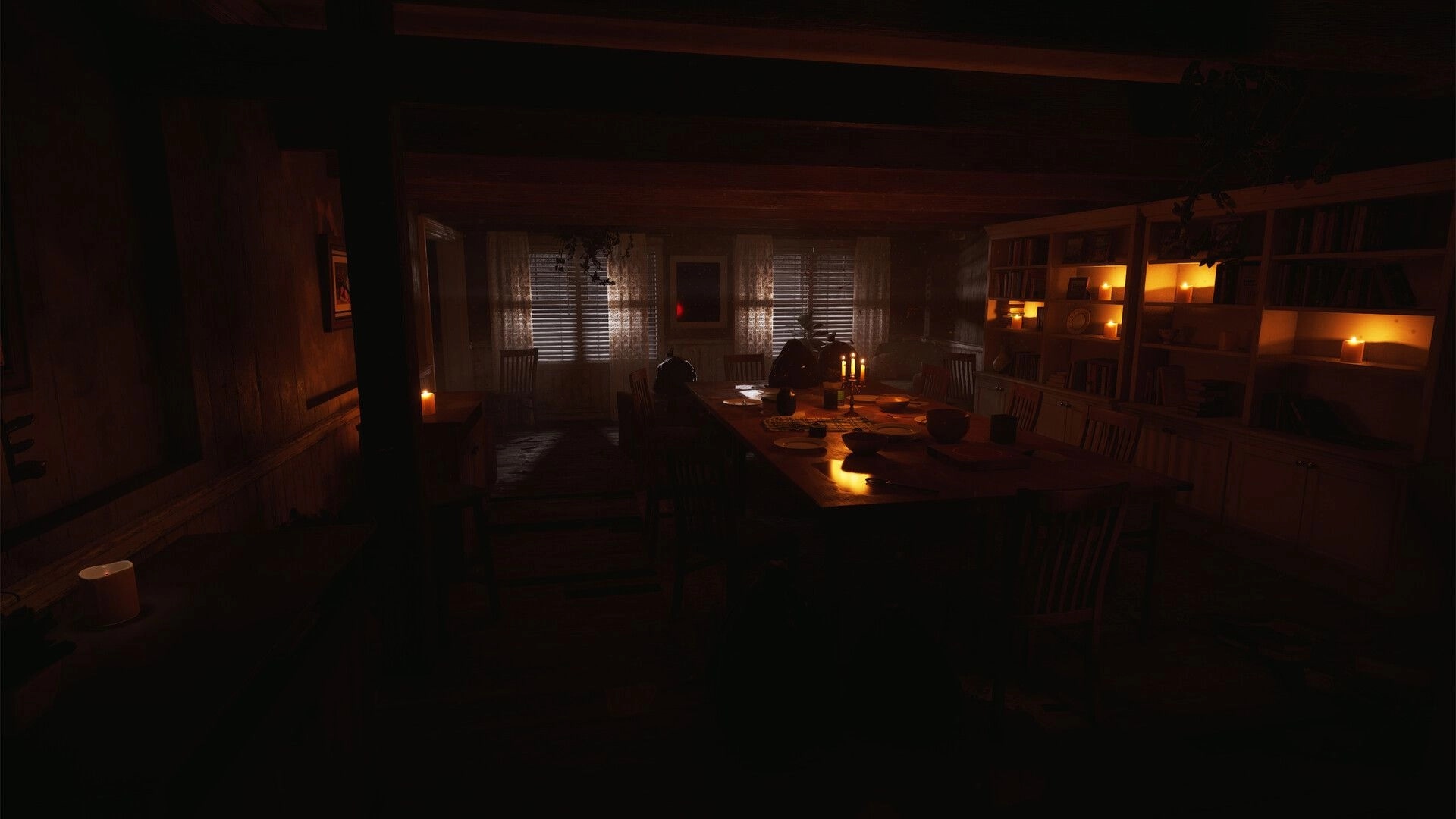 Paresis® II: Candlelit dining room with long table set for dinner, seen through dark branches.
