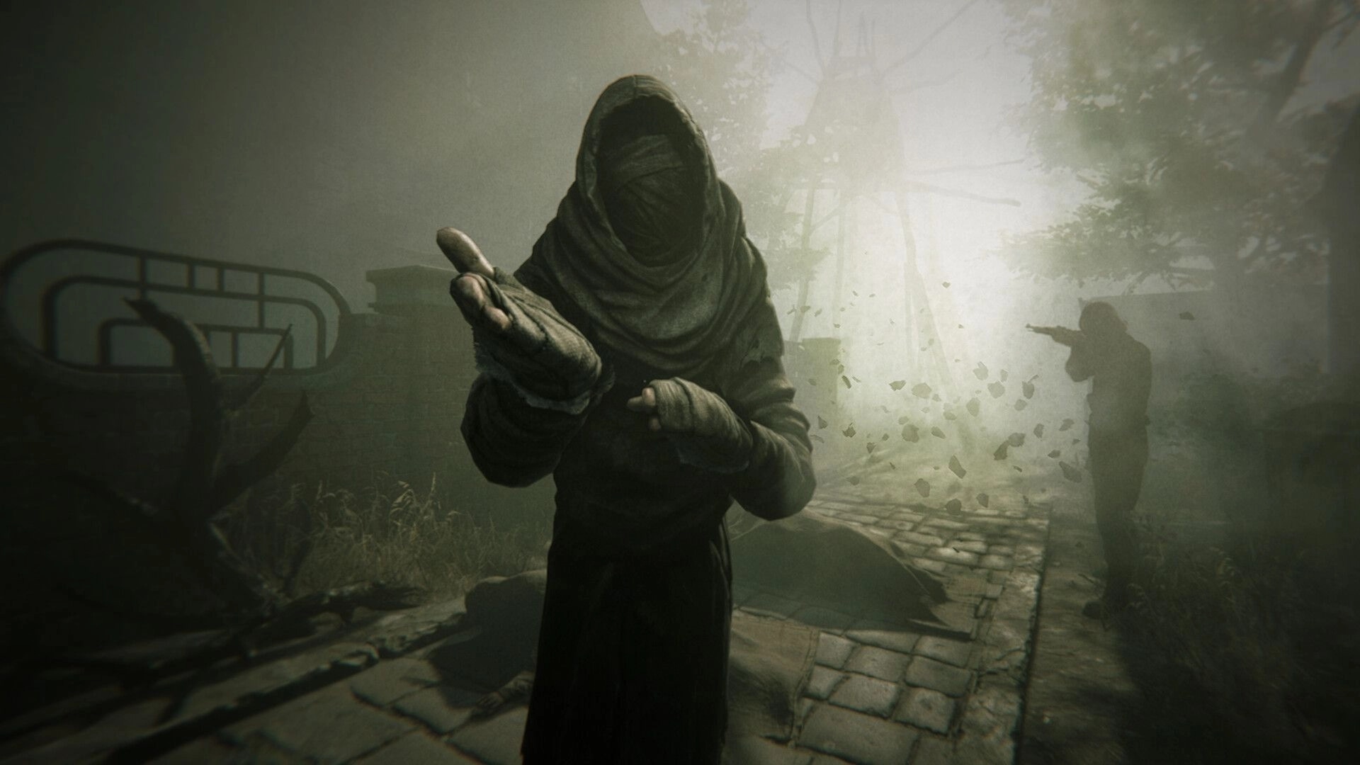 Pathologic 3: Hooded figure extends hand in foggy town square with another character aiming a rifle nearby.