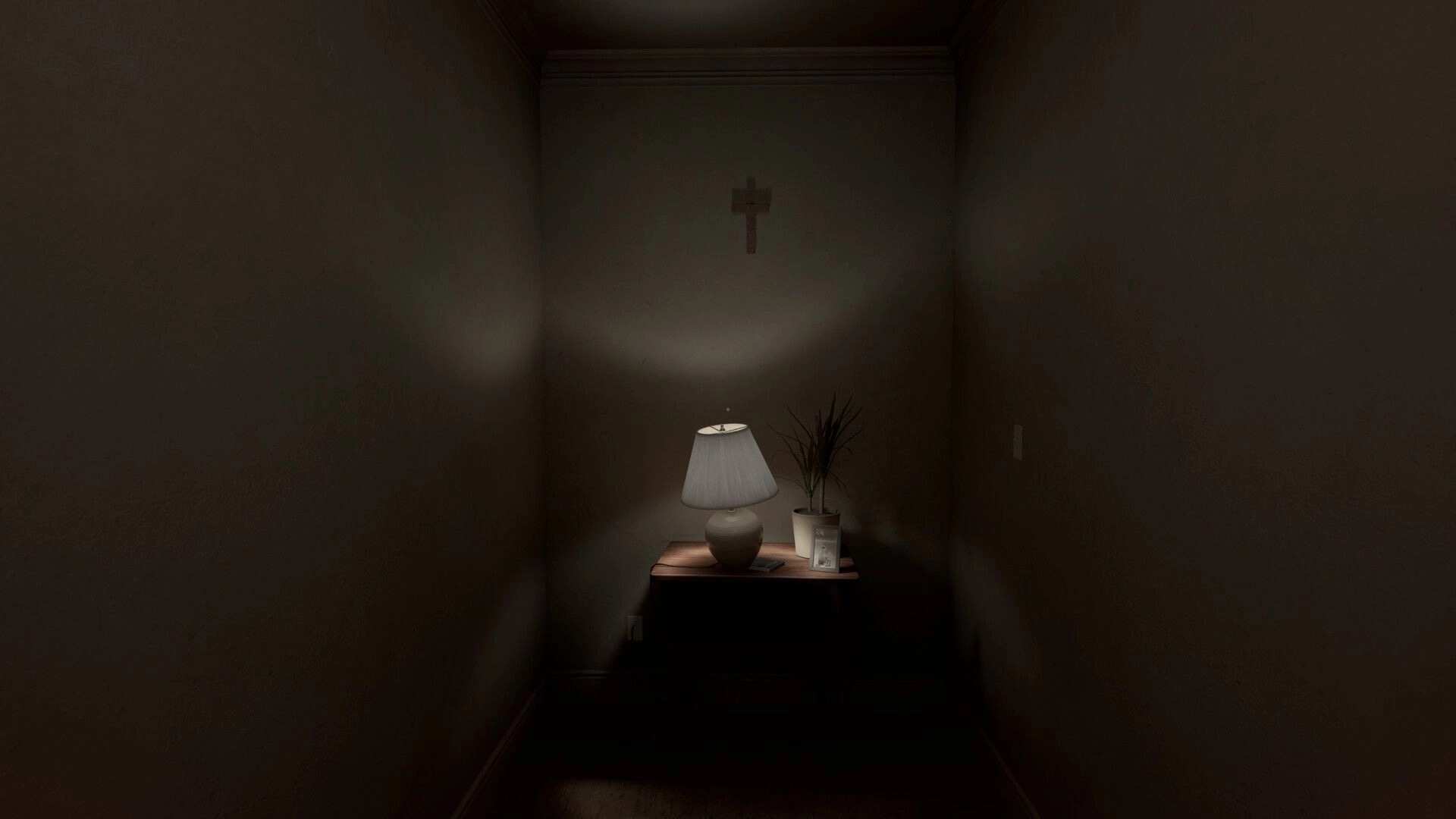 Perceptum: Flashlight beam on a hallway table with lamp, photo frame, and wall cross in dim house.