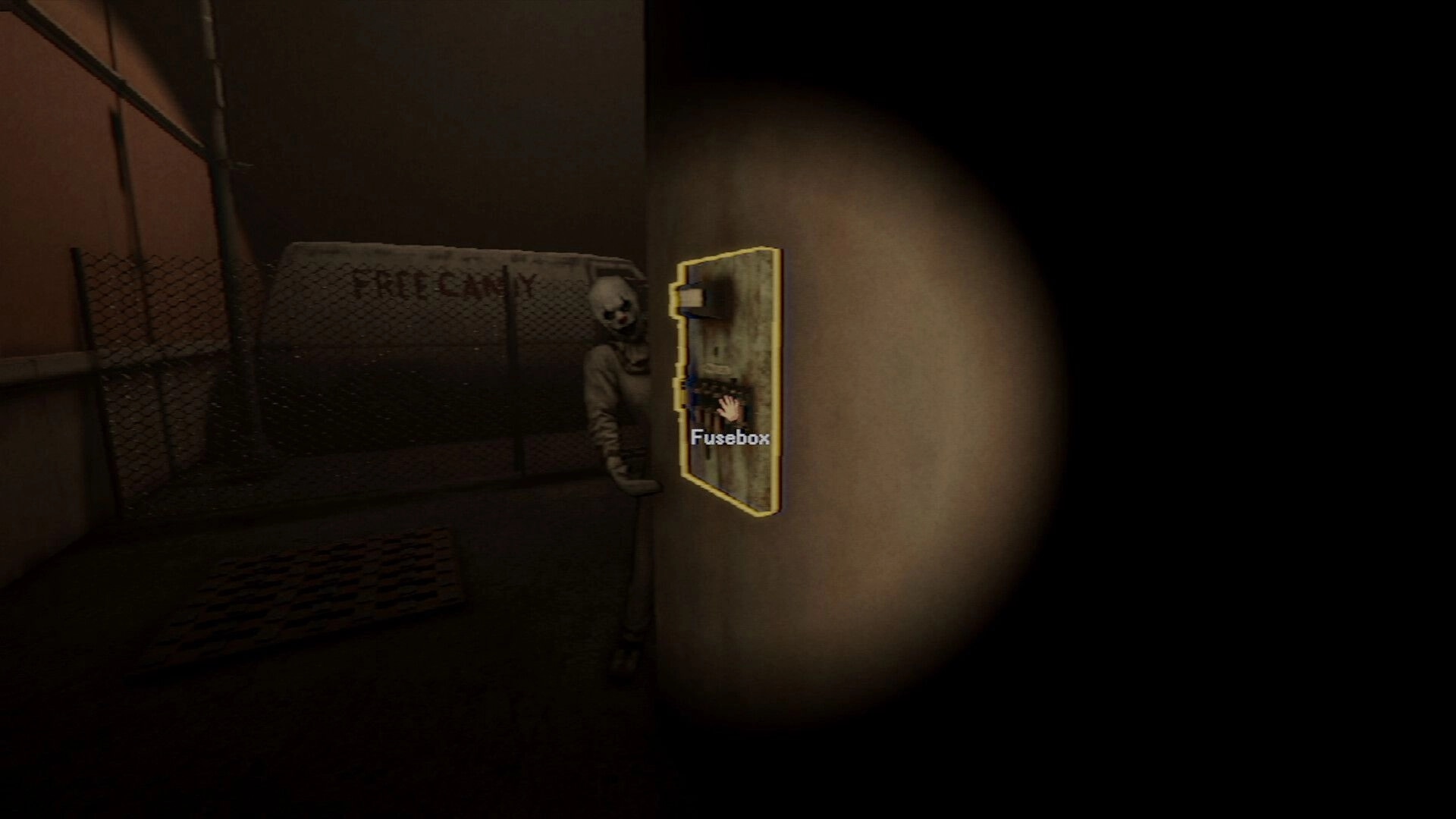 Photomaly: Interact prompt on fusebox as a masked figure lurks in a dim, fenced hallway corner.