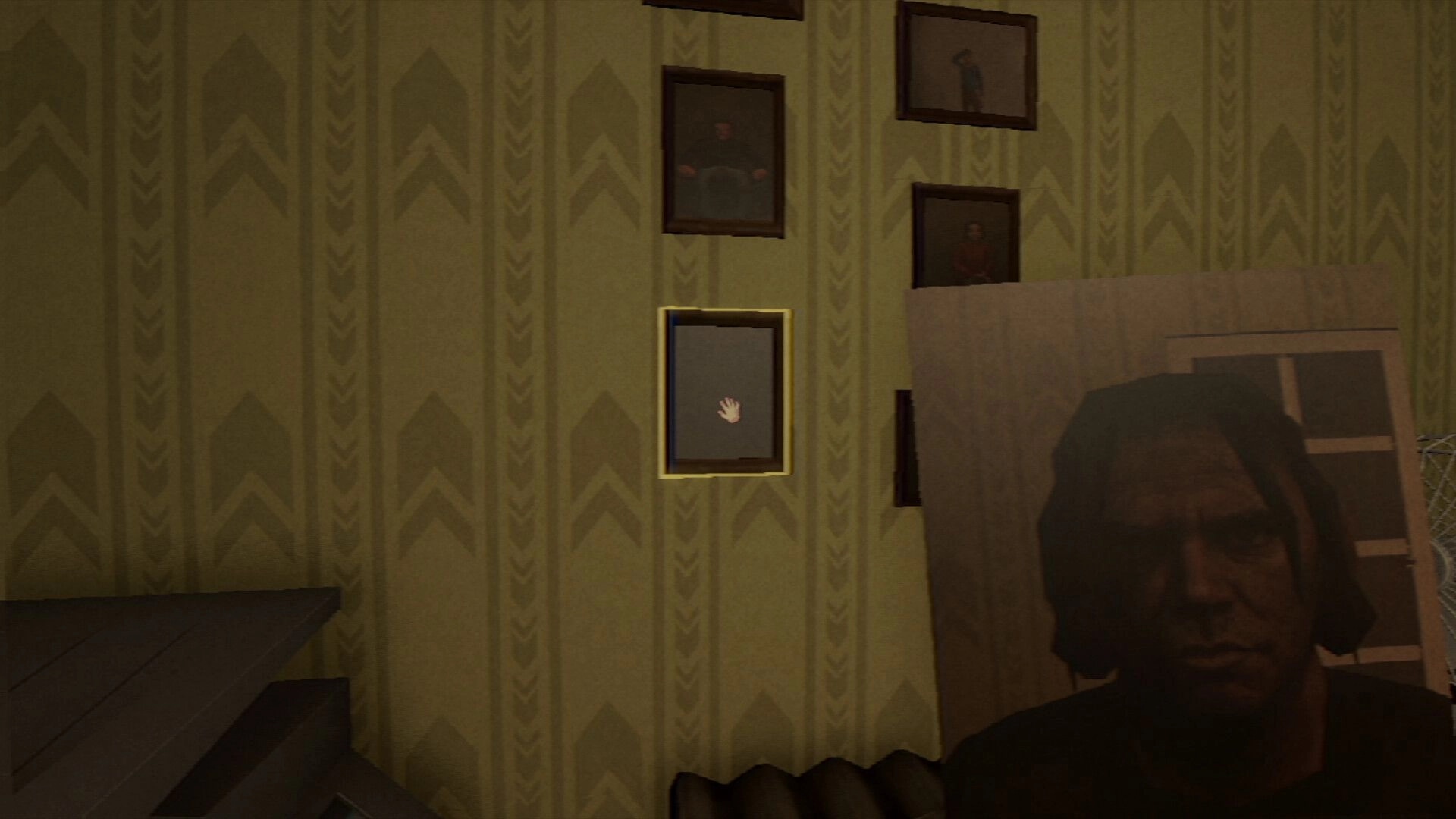 Photomaly: Hand cursor highlights a framed photo on patterned wall, with blurred figure in foreground.