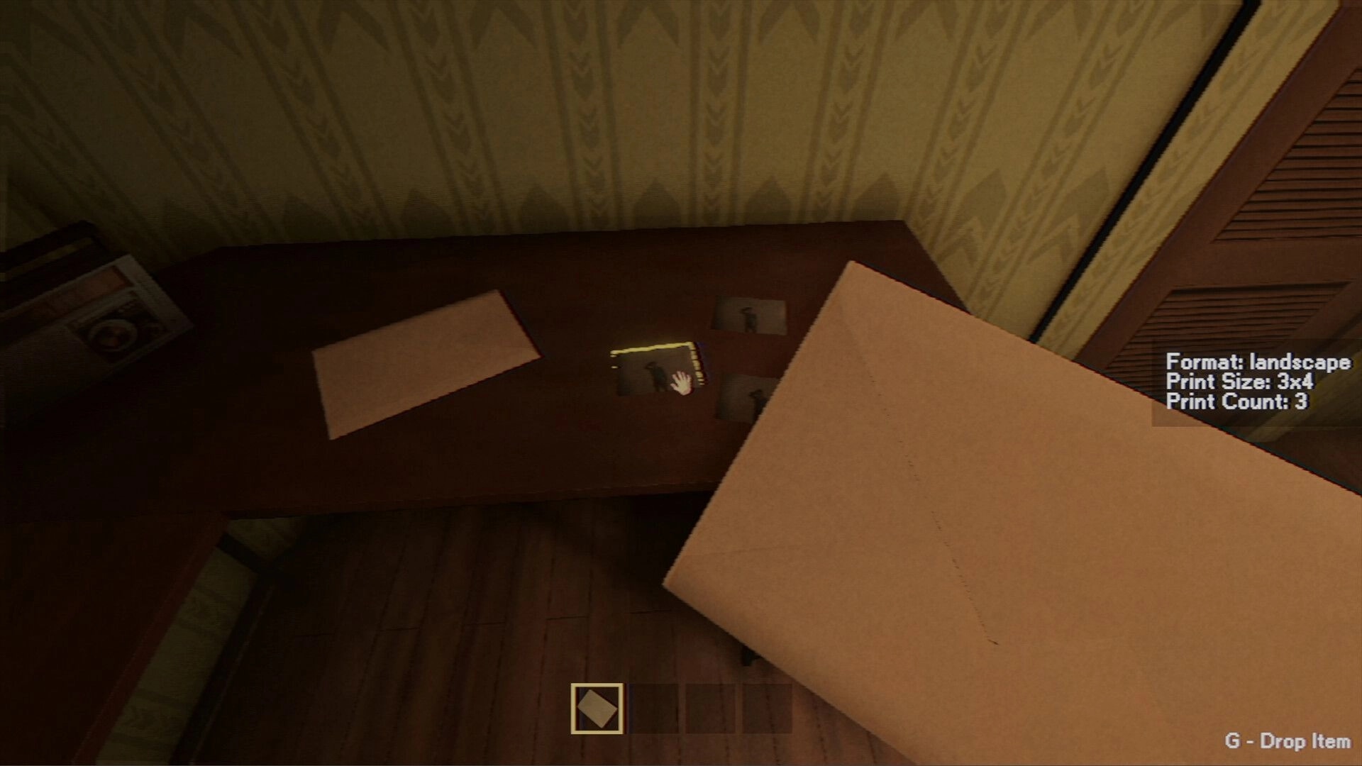 Photomaly: Holding a photo envelope over a desk with prints, UI lists format, size 3x4, count 3.