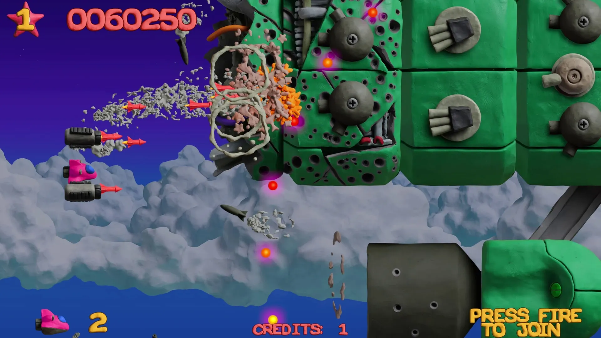 Platypus Reclayed: Player ship firing missiles at large green enemy in cloudy sky environment