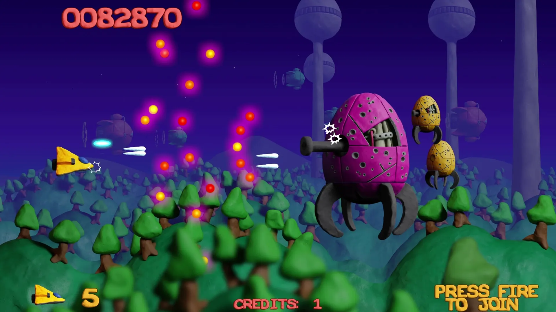 Platypus Reclayed: Yellow ship firing at enemy robots in a colorful forest with score and credits shown