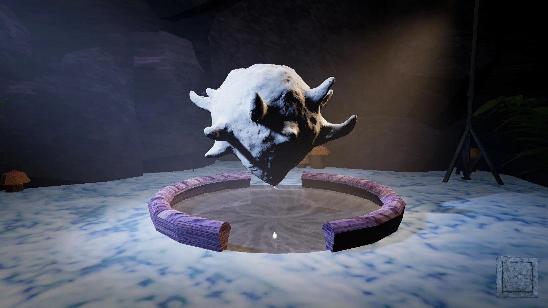 Plum Road Tea Dream: Floating stone mask above circular pool in a dimly lit cave environment.