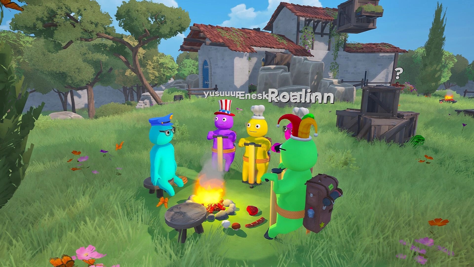 Pogo With Friends: Four pogo characters gather by a campfire in a grassy village with crates and house ruins.