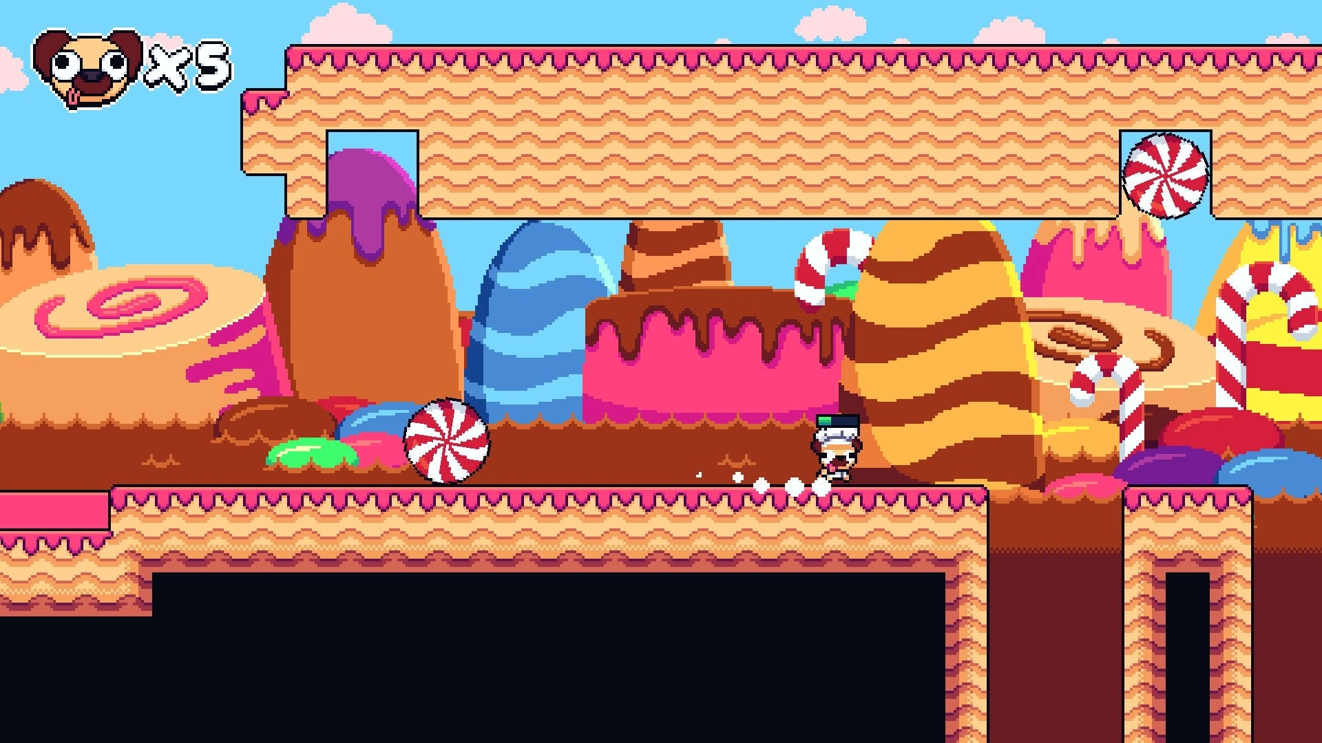 Pogui: Running through candy-themed level with peppermint obstacles and a life counter visible