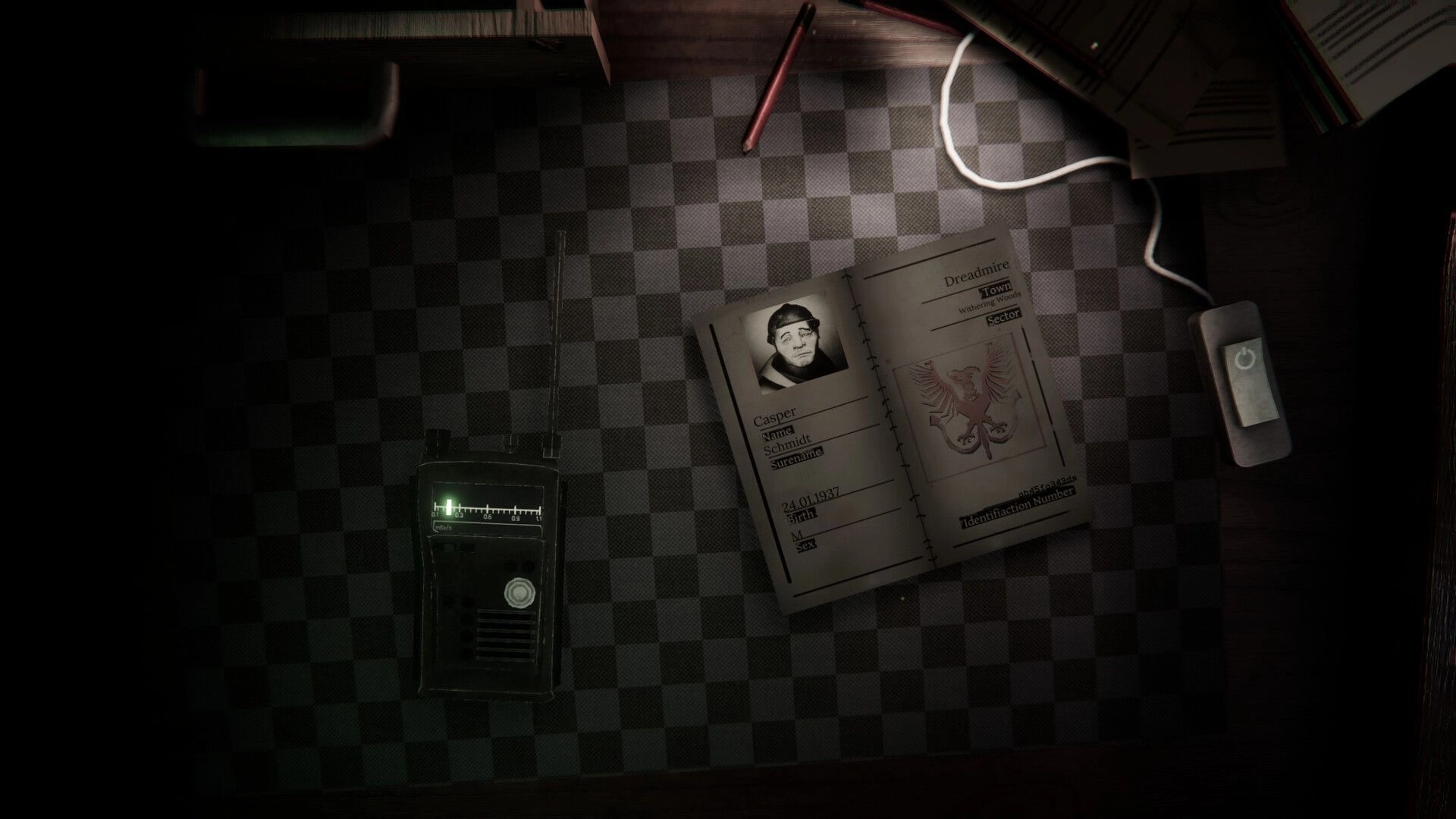 Protocol Non-Human: Inspecting Casper Schmidt ID booklet beside radio on checkered desk in booth.