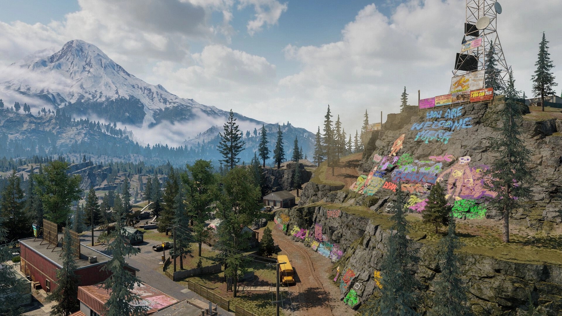 PUBG: Scenic overlook of mountain valley with graffiti-covered cliff, radio tower, and small town below.