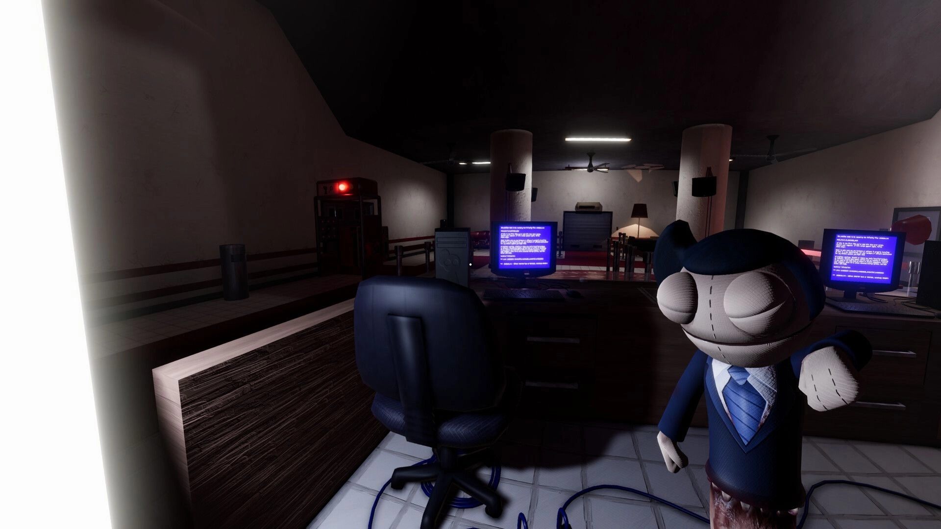 Puppetsite: Doll in suit stands by desk with blue error monitors in dim office lobby area.