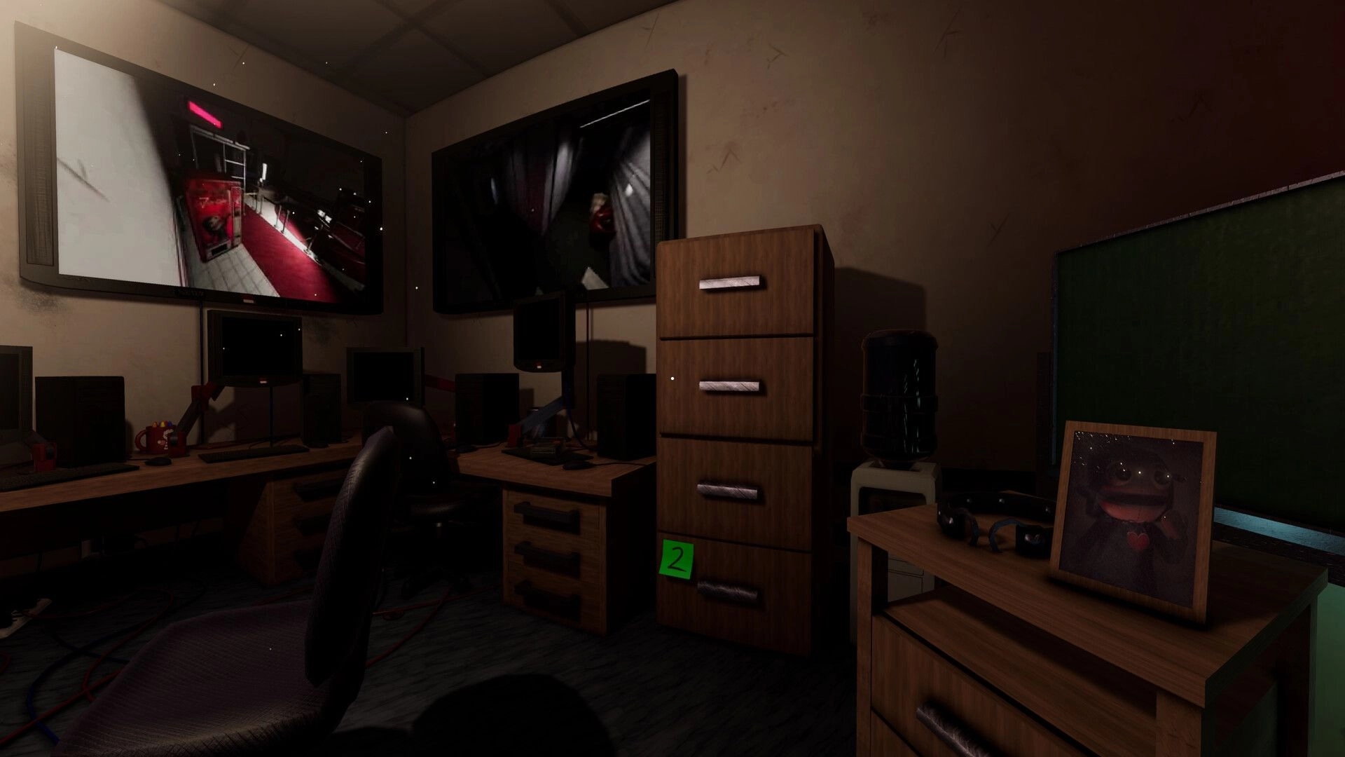 Puppetsite: Surveillance office with desk monitors, filing cabinet, and puppet photo in dim room.
