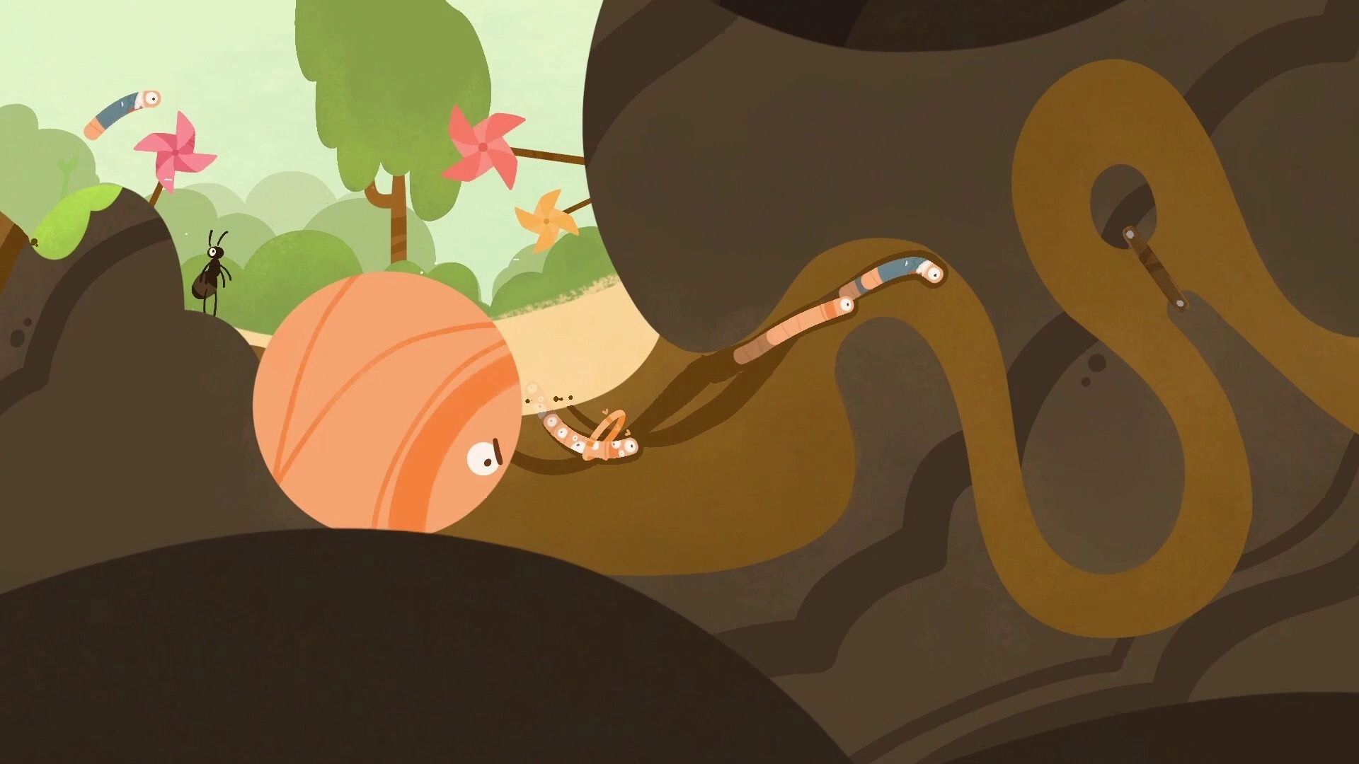 RaceWorms: Worms racing through underground tunnels with obstacles and a vibrant green landscape above