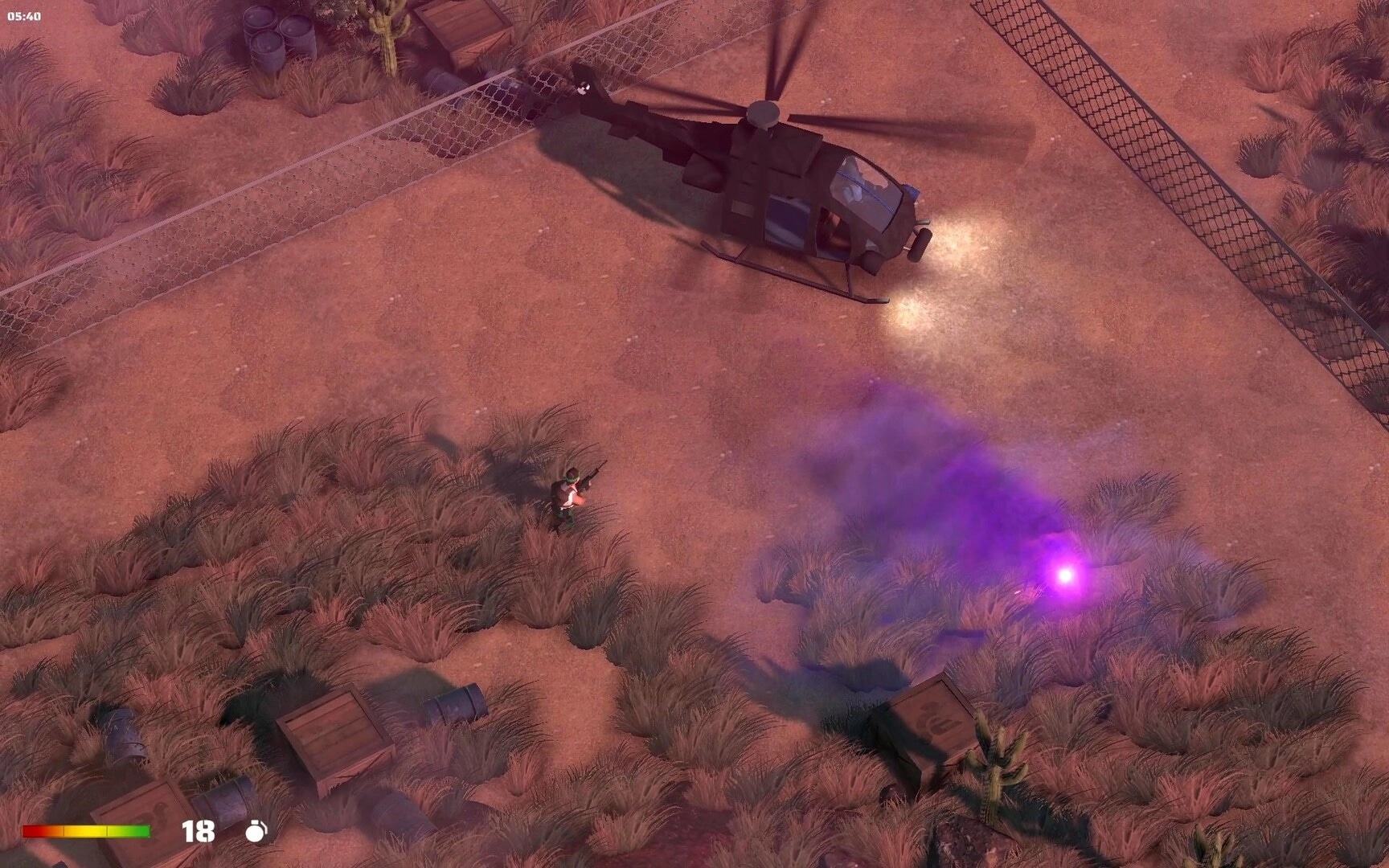RANGER COMMANDO: Player near helicopter in desert terrain with purple smoke and scattered crates visible