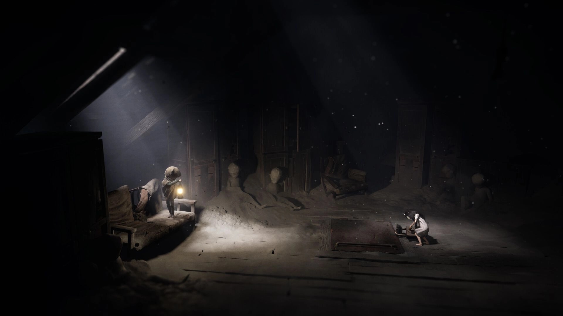 REANIMAL: Two characters exploring a dimly lit, dusty attic with statues and old furniture scattered around.