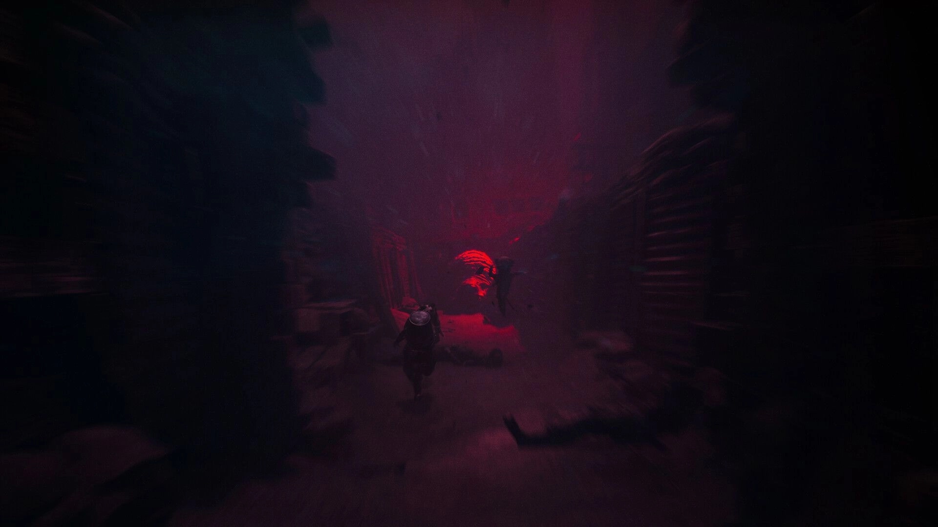 REANIMAL: Characters running through a dark, eerie corridor illuminated by a red glow in the background.