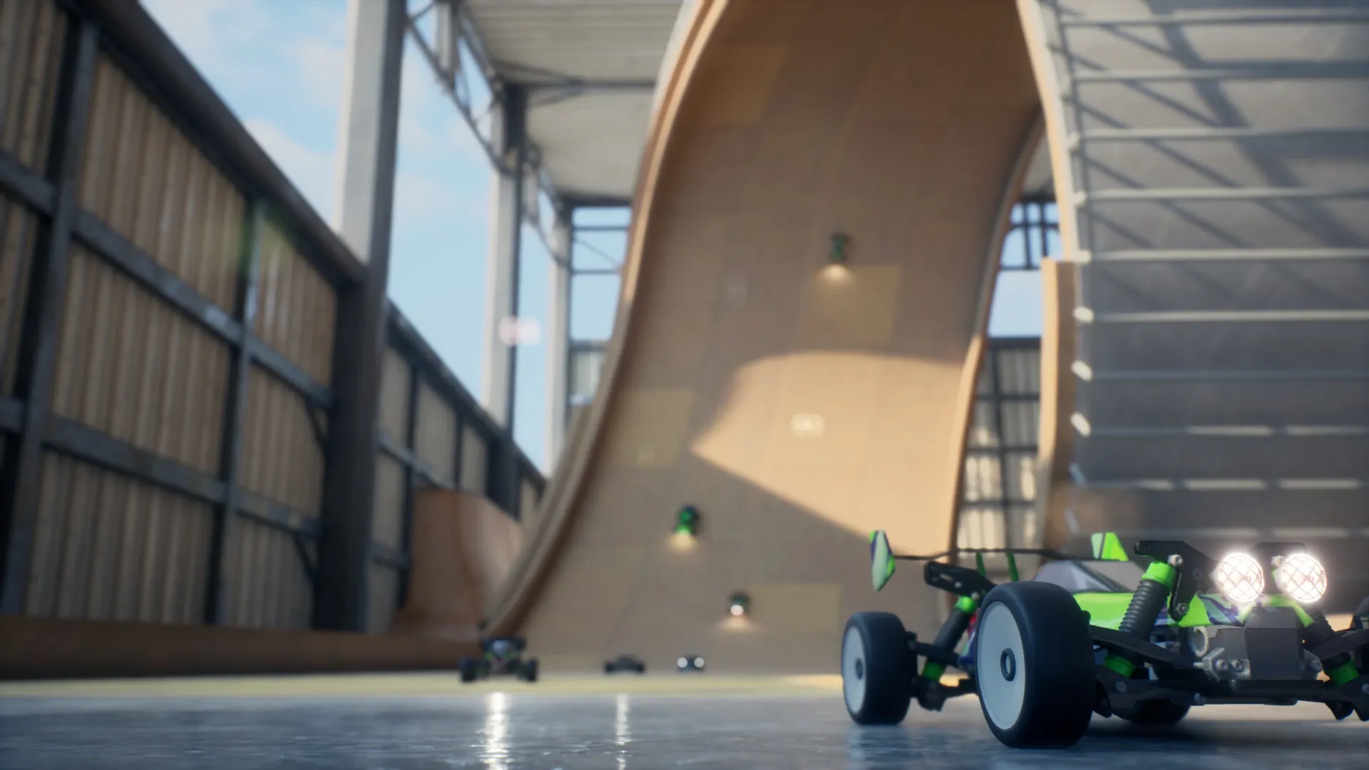 Recharge: RC cars racing on a large indoor track with a steep ramp under a metal-framed roof