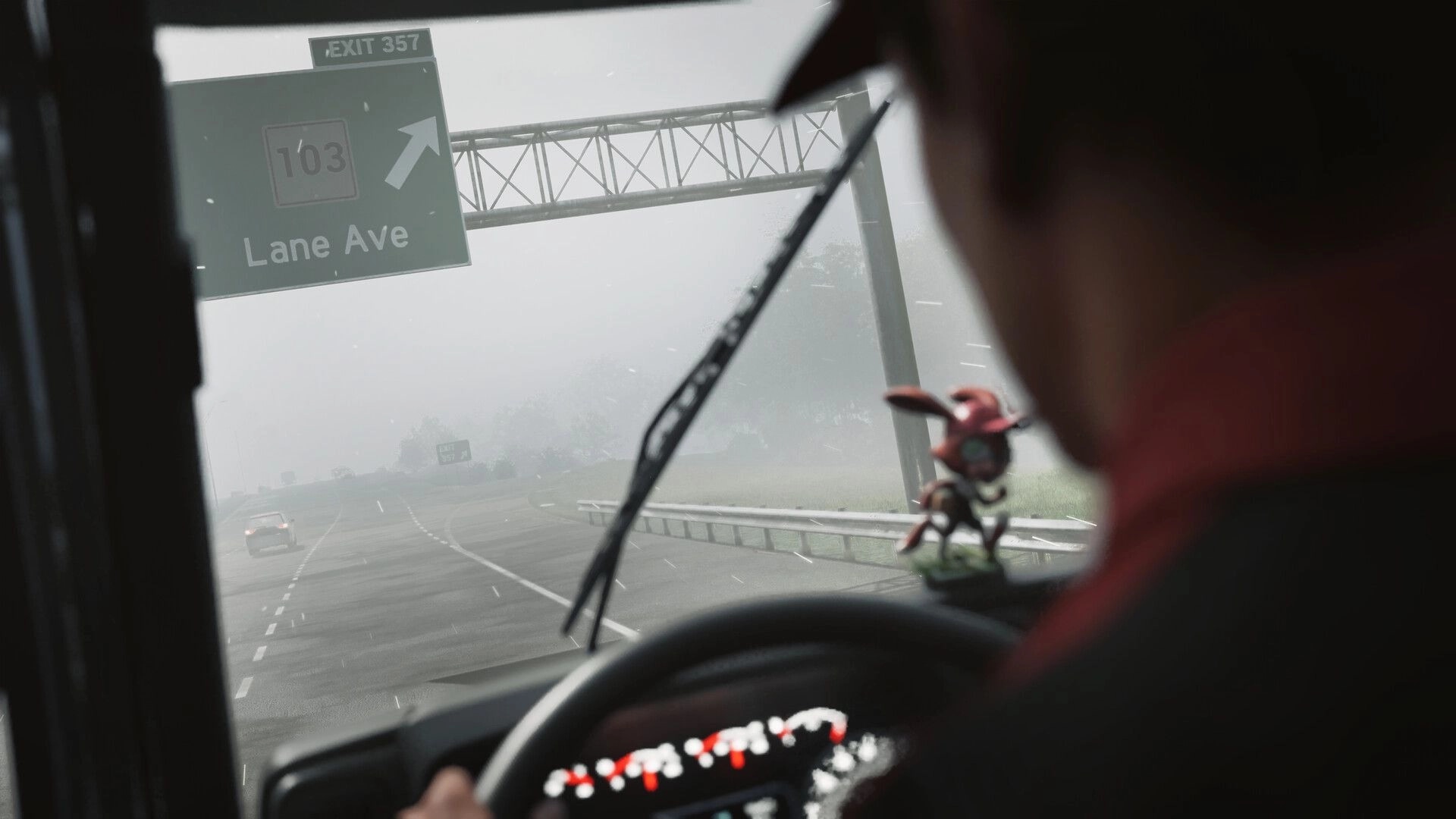 Road Kings: First-person cab view driving in rain past Exit 357 sign on foggy highway interchange.