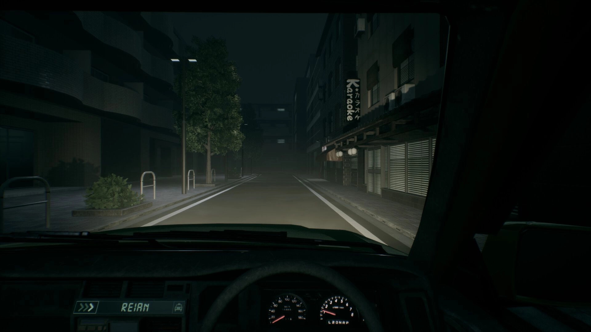 Road to Jukai: Driving at night from taxi cab view past a karaoke sign on a foggy city street.
