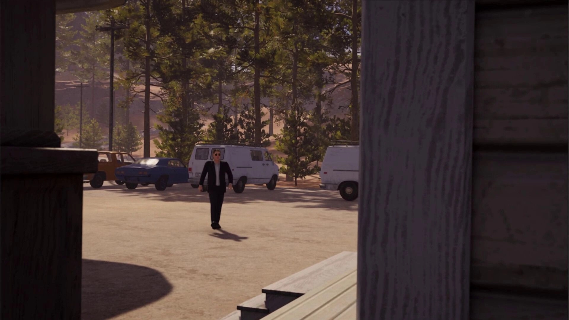 Roadside Research: Alien in a suit walks towards parked vans in a forested gas station setting