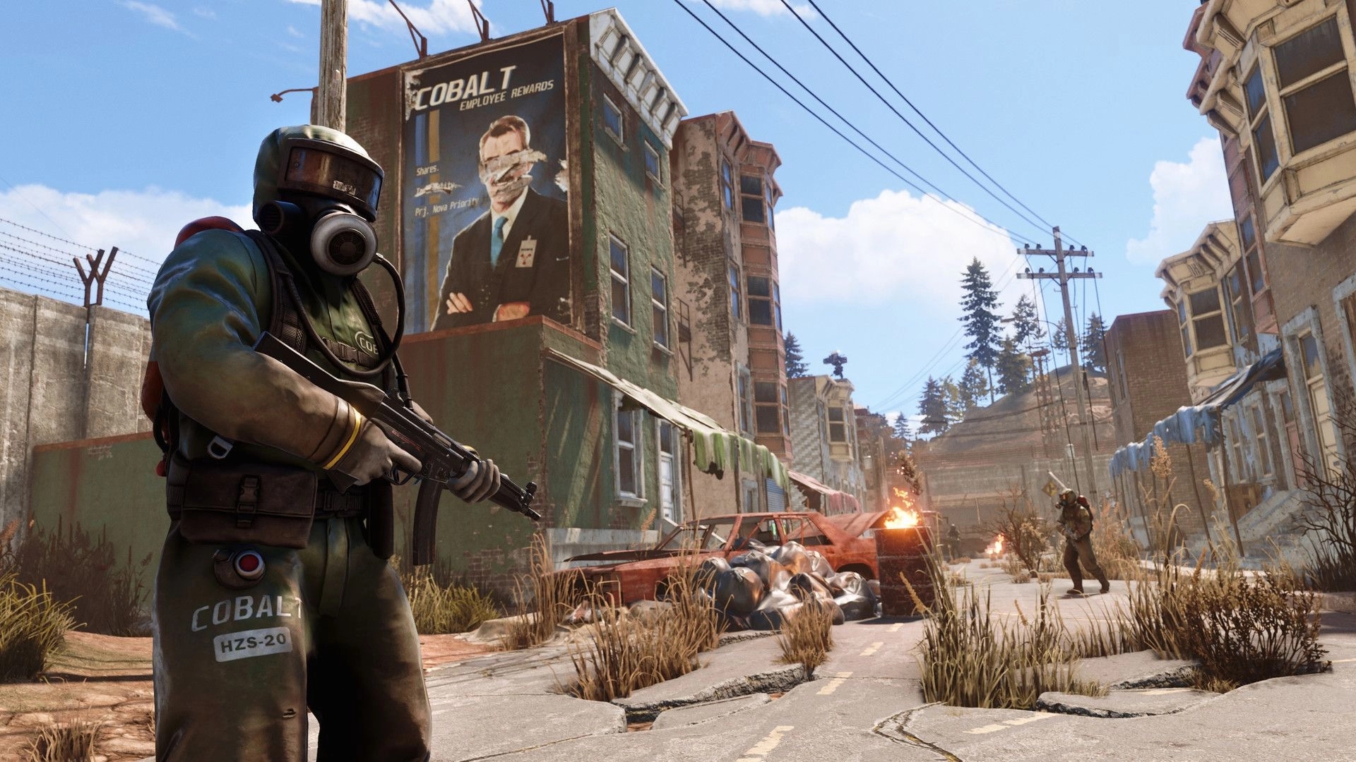 Rust: Armed player in hazmat suit patrols abandoned urban street with burning barrels and damaged cars