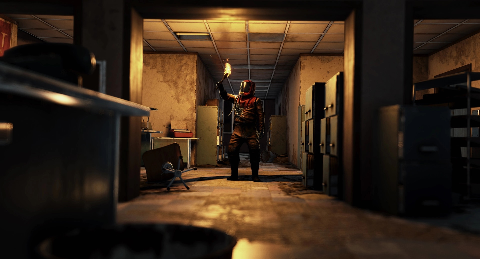 Rust: Player holding torch in dark, abandoned office hallway with scattered debris and filing cabinets
