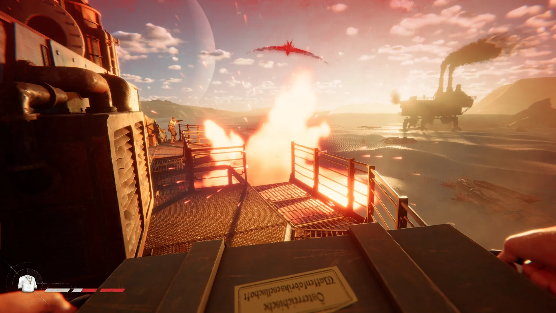 Sand: Player holds a box on a Trampler platform with distant smoke, fiery explosion, and sunset sky.