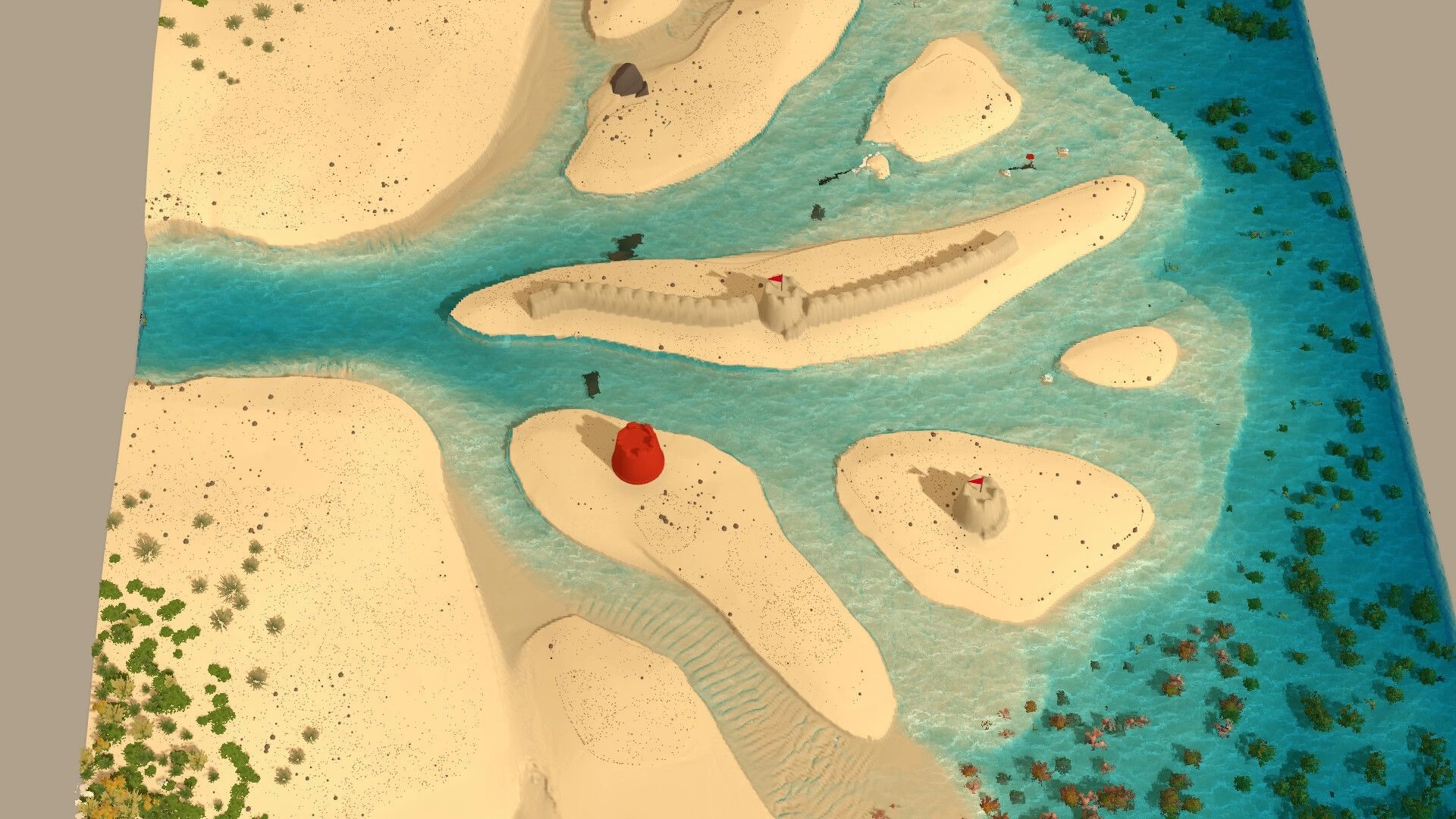 Sandcastle: Top-down view of sandcastles with red flags on small islands in shallow blue water.