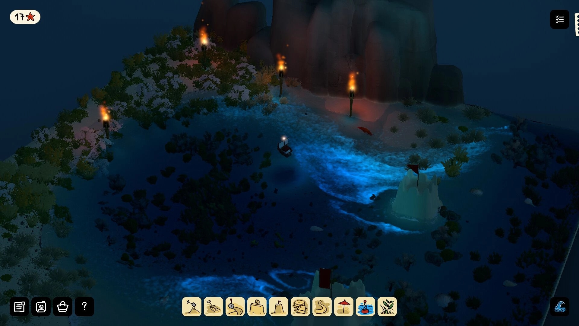 Sandcastle: Night beach building view with torches, rocky cliffs, and tool hotbar along bottom UI.