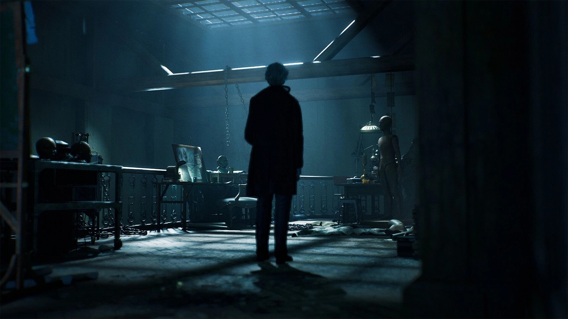 SAW: Silhouetted figure enters a dim workshop with hanging chains, mannequins, and tables of tools.