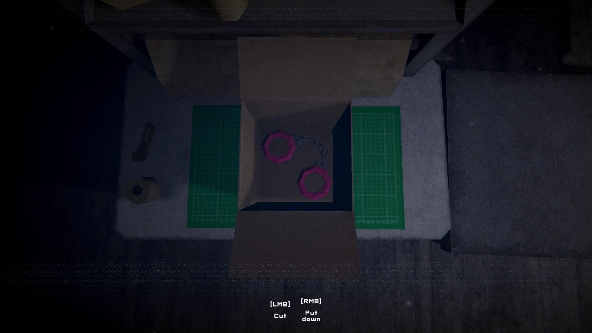 Sender Unknown: Open box with pink handcuffs on a workbench, cut and put down prompts below.