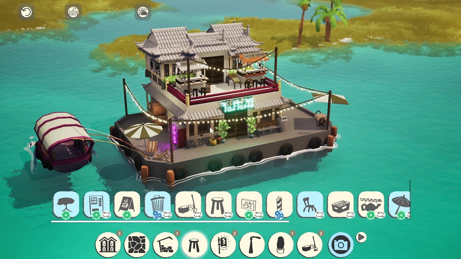 ShantyTown: Floating riverside cafe build with decor toolbar and camera button on turquoise water.