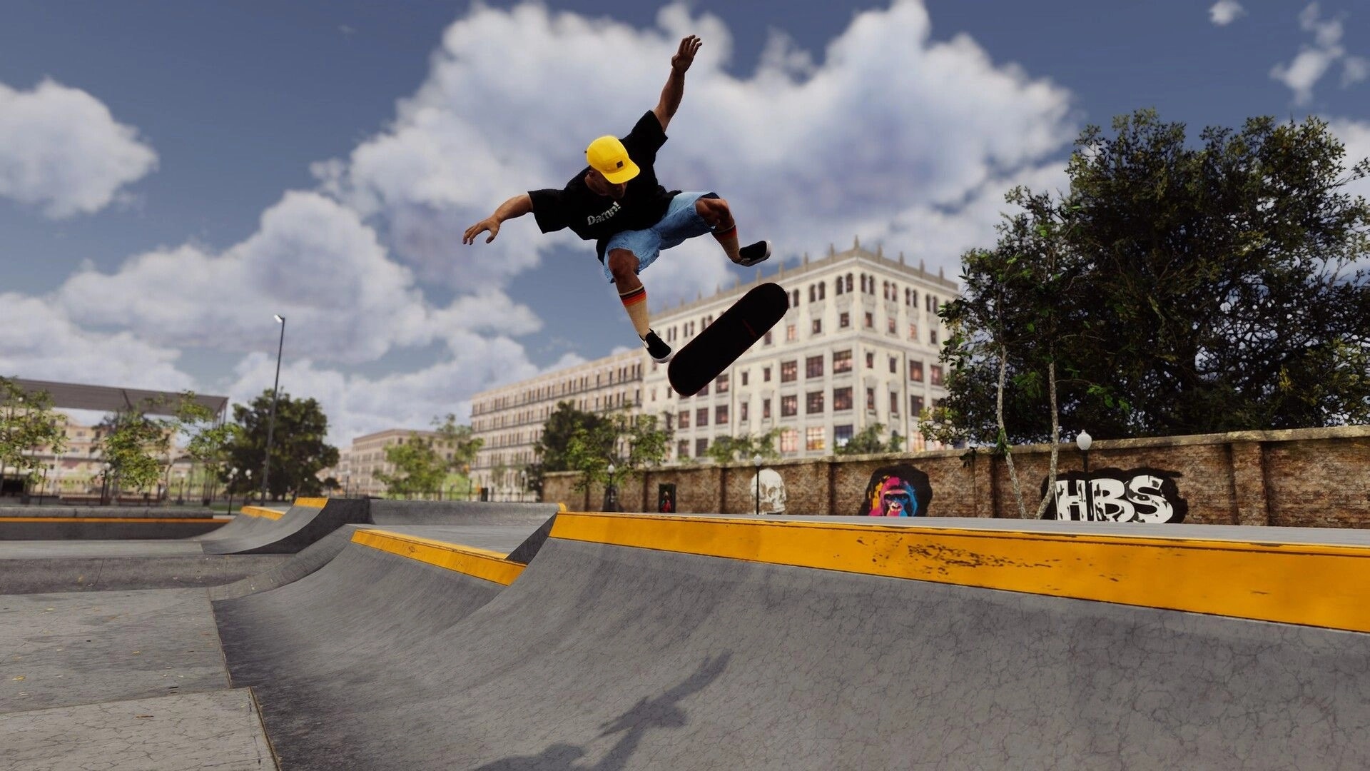 Skate Style: Skater in yellow cap performs a kickflip over ledge at urban skatepark by graffiti wall.