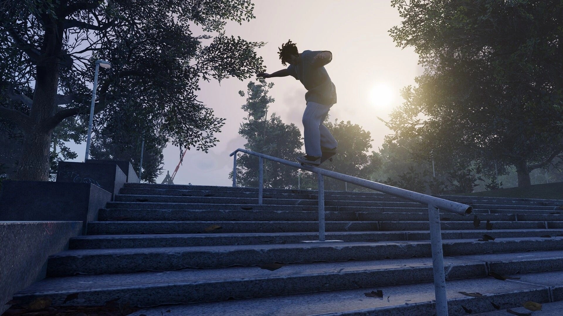 Skate Style: Skater grinding a long handrail over wide stairs in a sunlit tree-lined park.